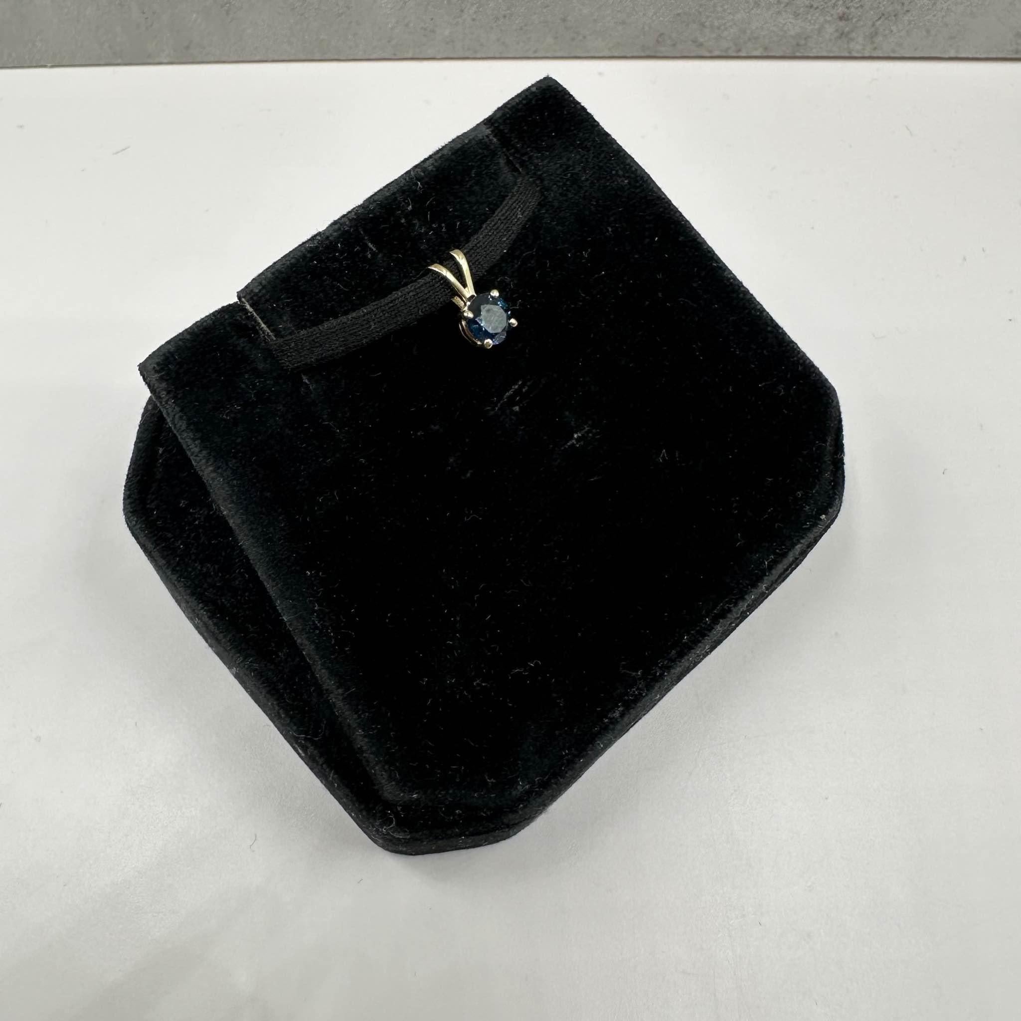This stunning Blue Sapphire Pendant in 14kt yellow gold features 0.55ctw of natural round blue sapphires, showcasing a gorgeous fine blue color. Weighing just 0.4 grams, it is lightweight and comfortable for daily wear. The bail will fit a small