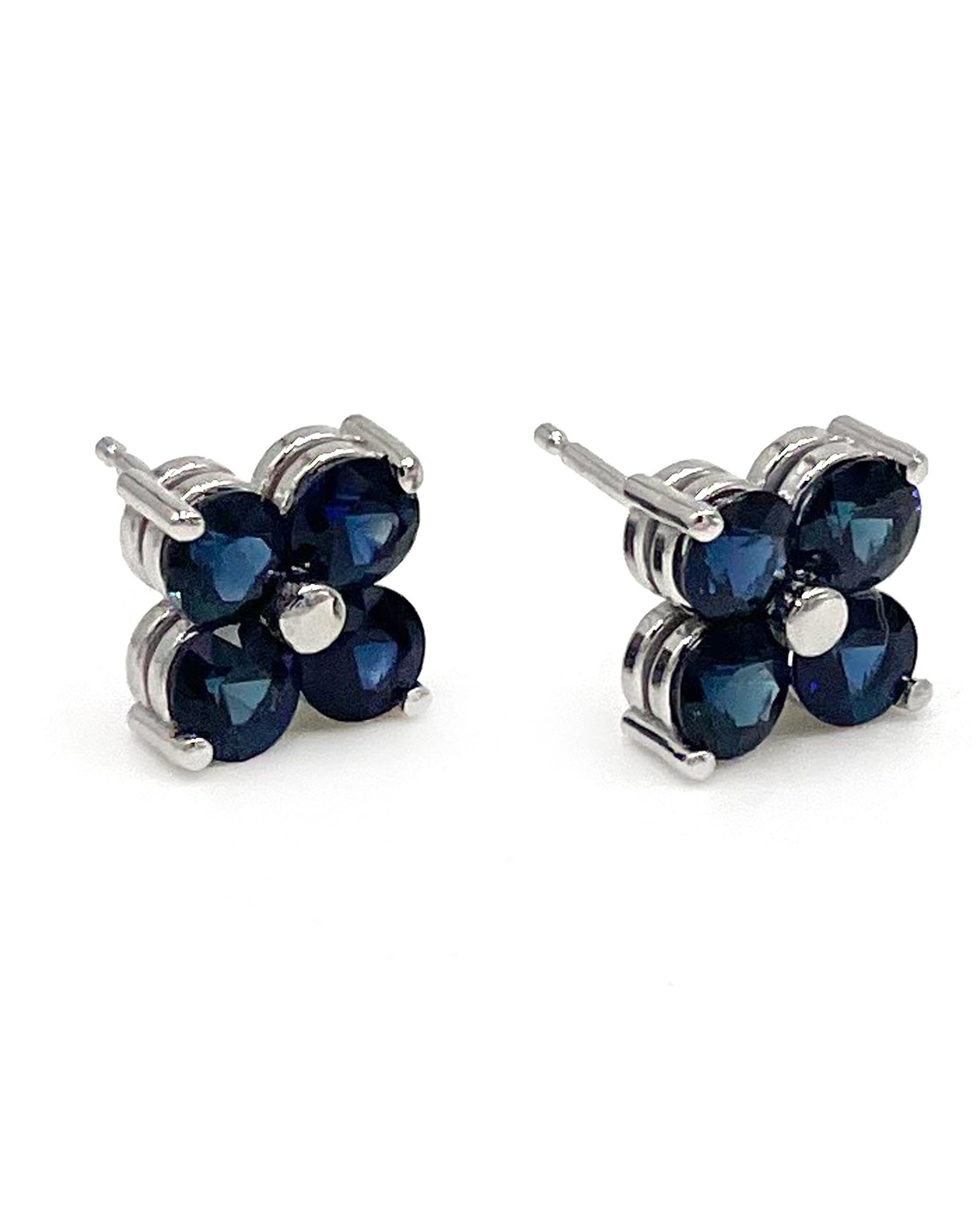 Pair of 14K white gold quatrefoil stud earrings with eight round blue sapphires 2.26 carats.