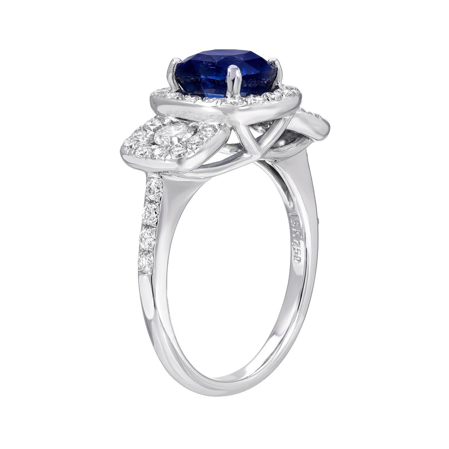 Sapphire ring featuring a Blue Sapphire cushion cut weighing a total of 2.35 carats, adorned by a total of 0.87 carat diamonds, in this gorgeous 18K white gold engagement ring or cocktail ring. 
Sapphire ring size 6.5. Re-sizing is complimentary