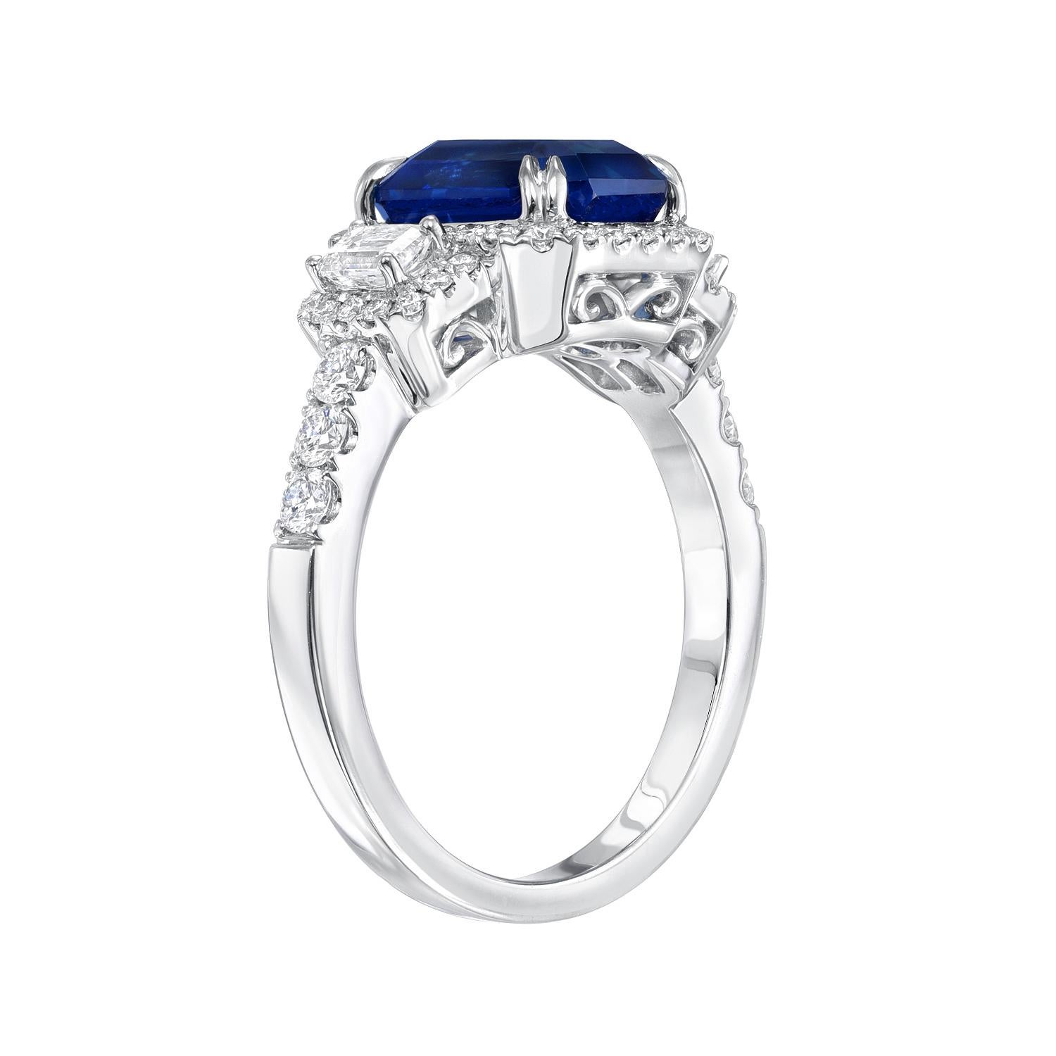 Classic 3.58 carat emerald-cut Blue Sapphire, 18K white gold ring, flanked by a pair of emerald-cut diamonds and round brilliant diamonds weighing a total of 0.77 carats. 
Ring size 6.5 Resizing is complementary upon request.
Crafted by extremely