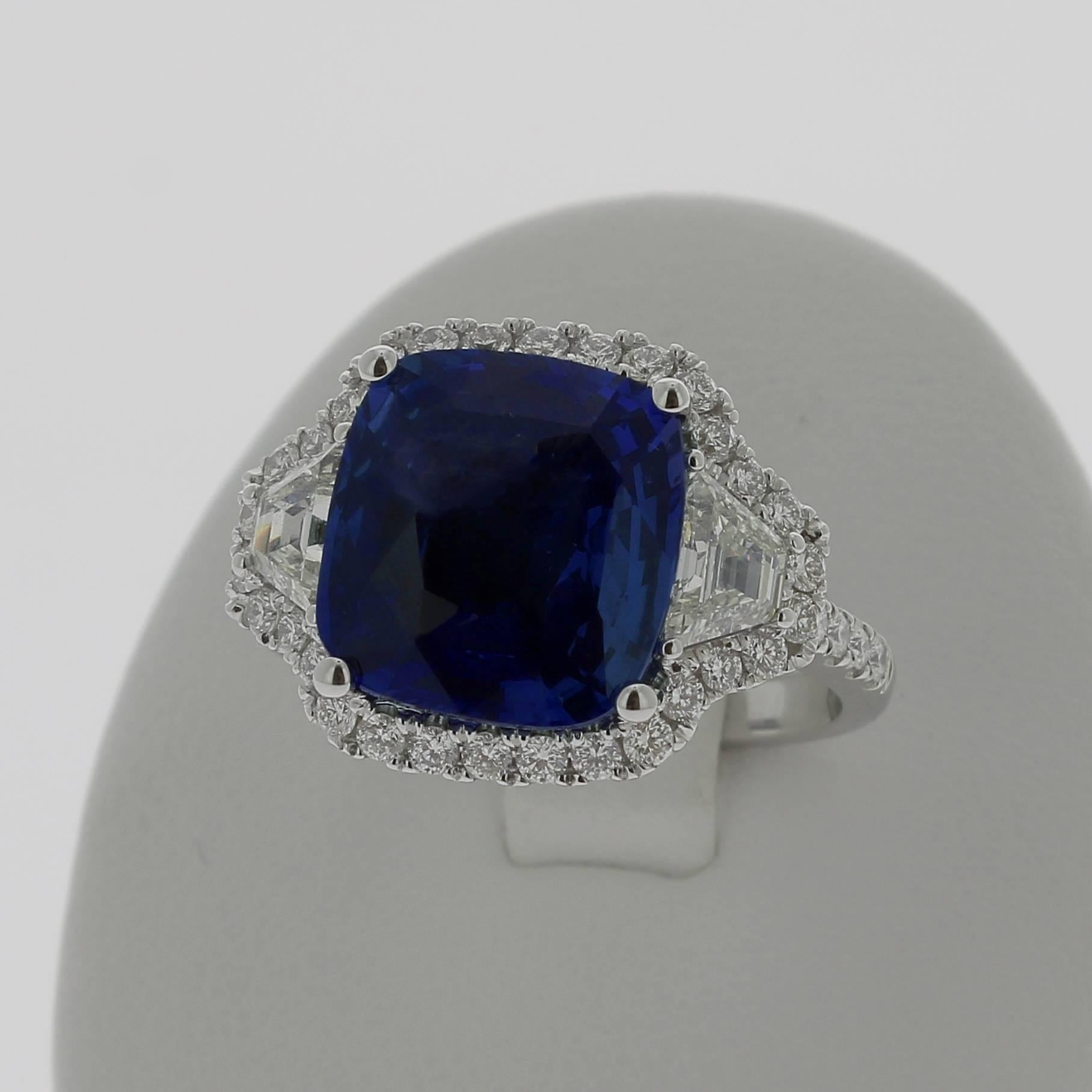 A Blue Sapphire Ring weighing 7.07 carats. 
The stone’s shape is cushion, with a striking Blue.
The ring is set with two trodia Diamond weighing 0.72 Carats and 40 Rounds Diamonds weighing 0.60 Carats.
The Sapphire is accompanied by a certificate