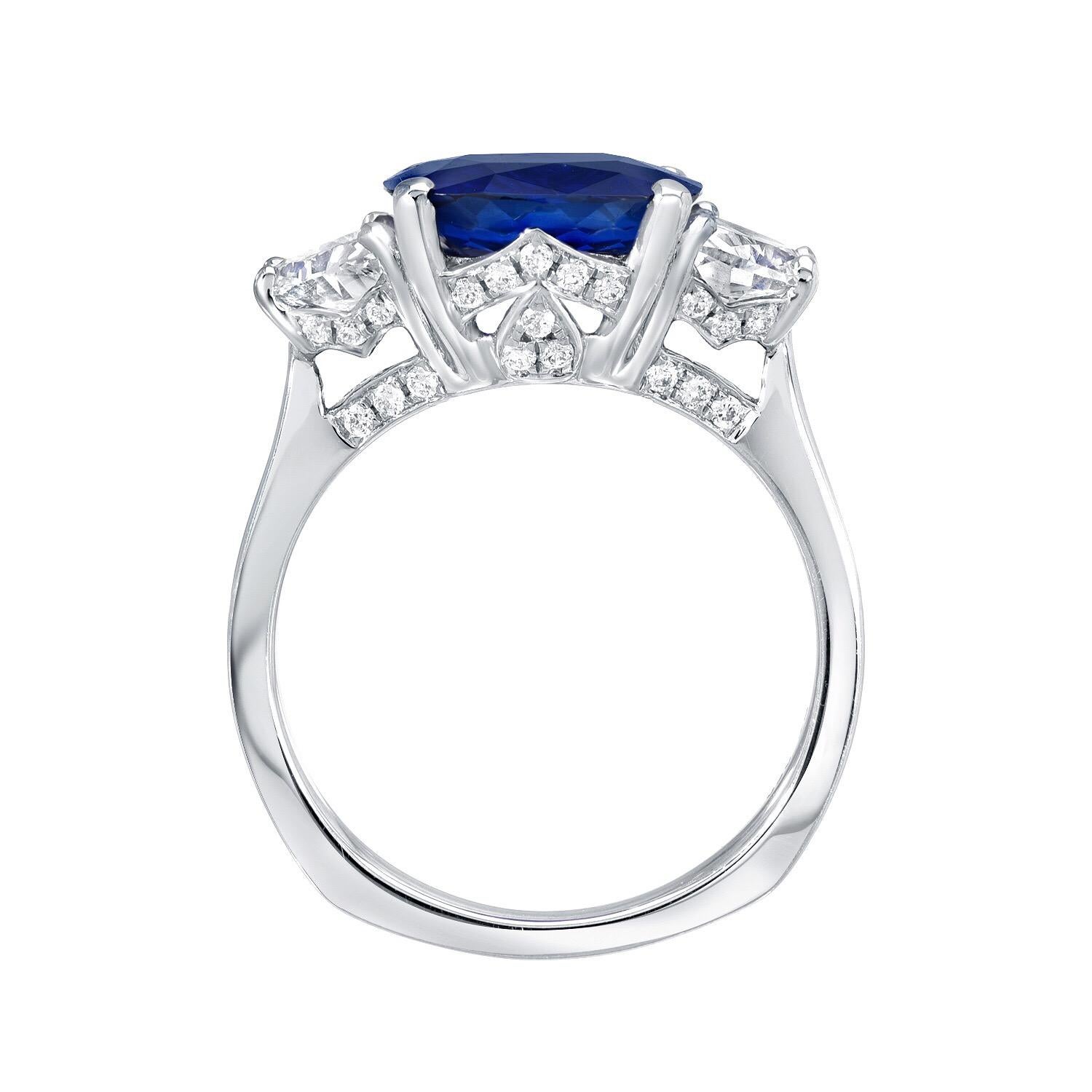 Sapphire ring featuring a vivid Royal Blue, 3.81 carat cushion cut Ceylon Sapphire, flanked by pair of half moon diamonds weighing a total of 0.89 carats, and adorned by a total of 0.28 carat round brilliant diamonds. This sensational platinum,