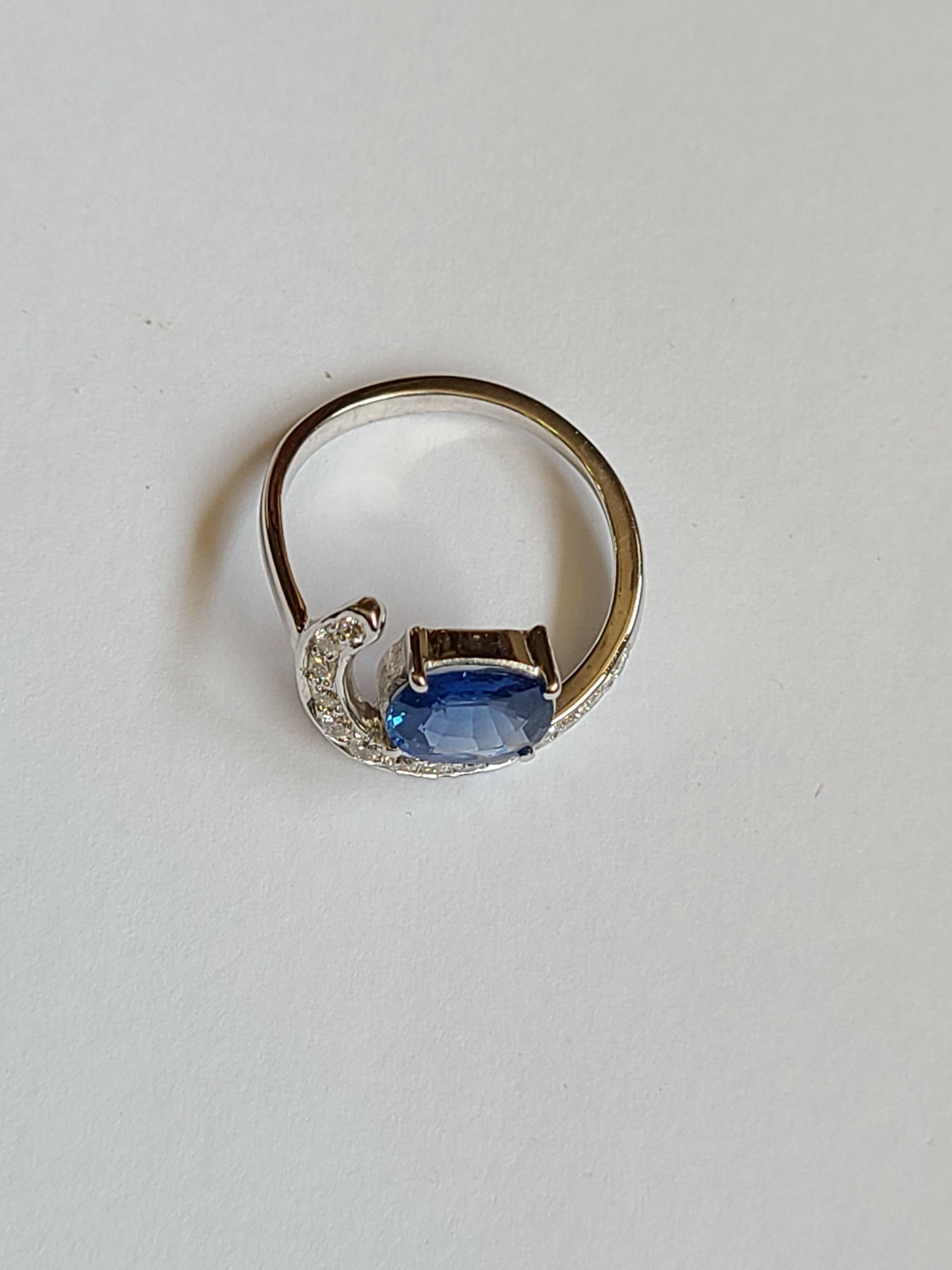 A beautiful and Chic blue sapphire ring set in 18k gold with diamonds. The blue sapphire is from sri-lanka and weight is 1.61 carats. The diamond weight is .26 carats. The ring dimensions in cm 1 x 1.8 x 2 (LXWXH). US size 5 1/2.
