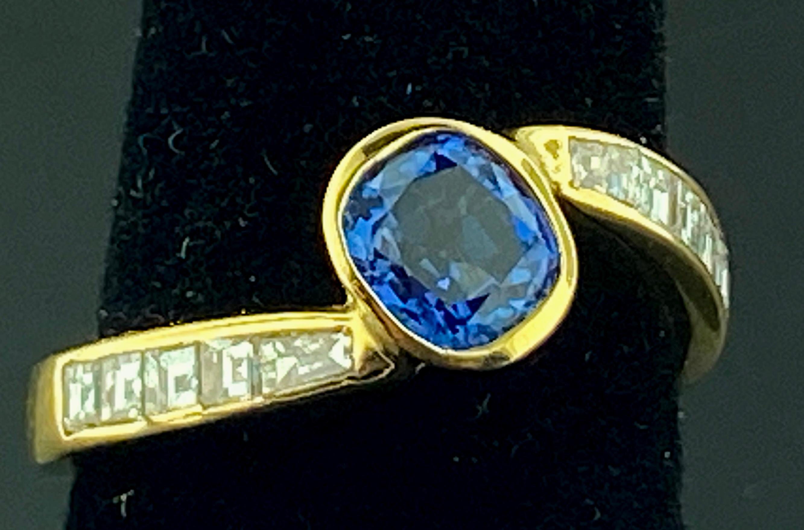 Set in 14 karat yellow gold is a 0.95 carat round blue sapphire with 10 baguette cut diamonds with a total diamond weight of 0.50 carats.  Color is G-H, Clarity is VS.  Ring size is 6.25.