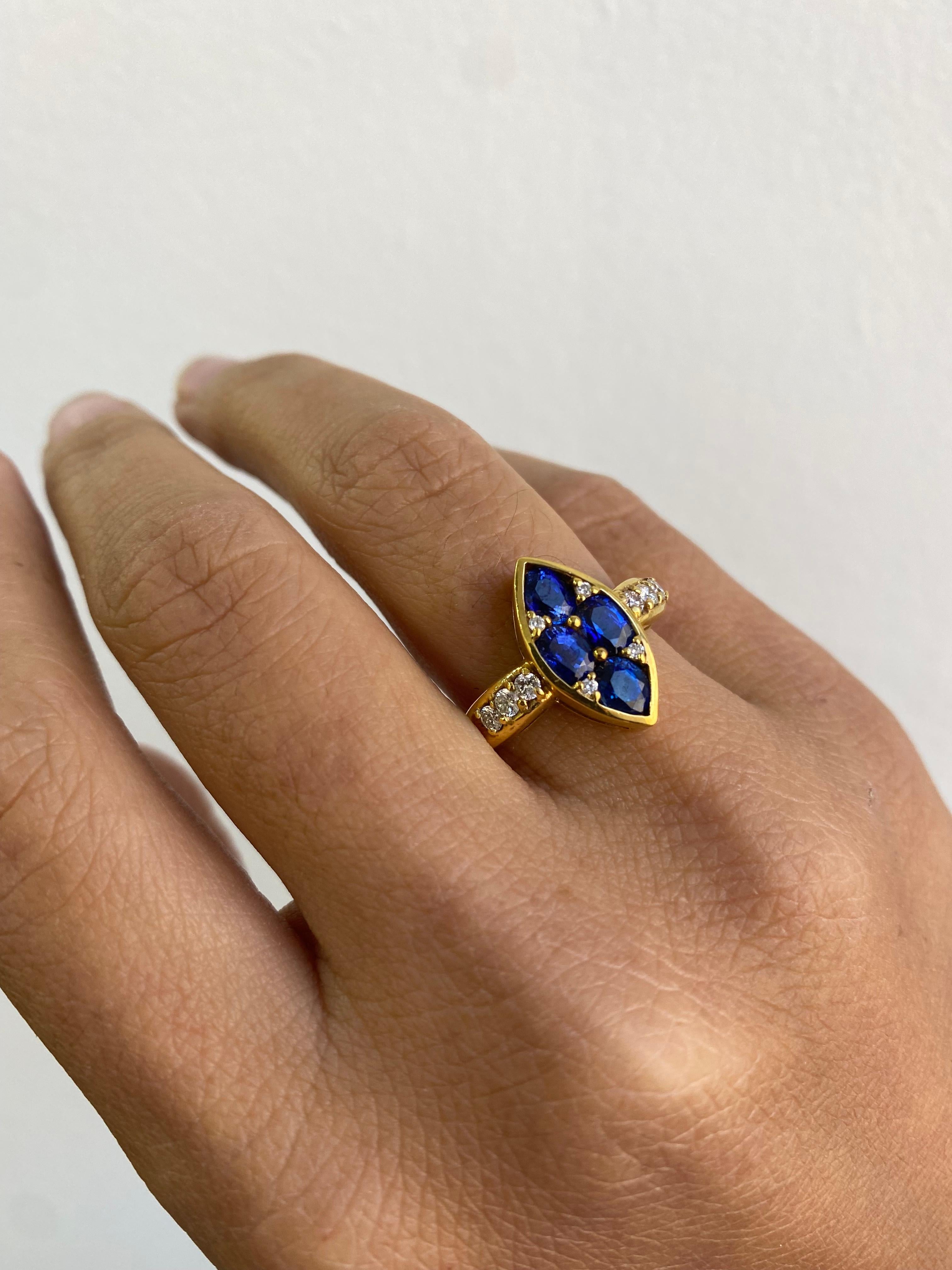 This unique piece features 4 vivid oval shaped natural blue sapphires designed into a marquee shape. Its gold band is set with pave diamonds and crafted in 14k yellow gold. 

Details: 
6 grams  14k yellow gold
10 round brilliant cut diamonds set