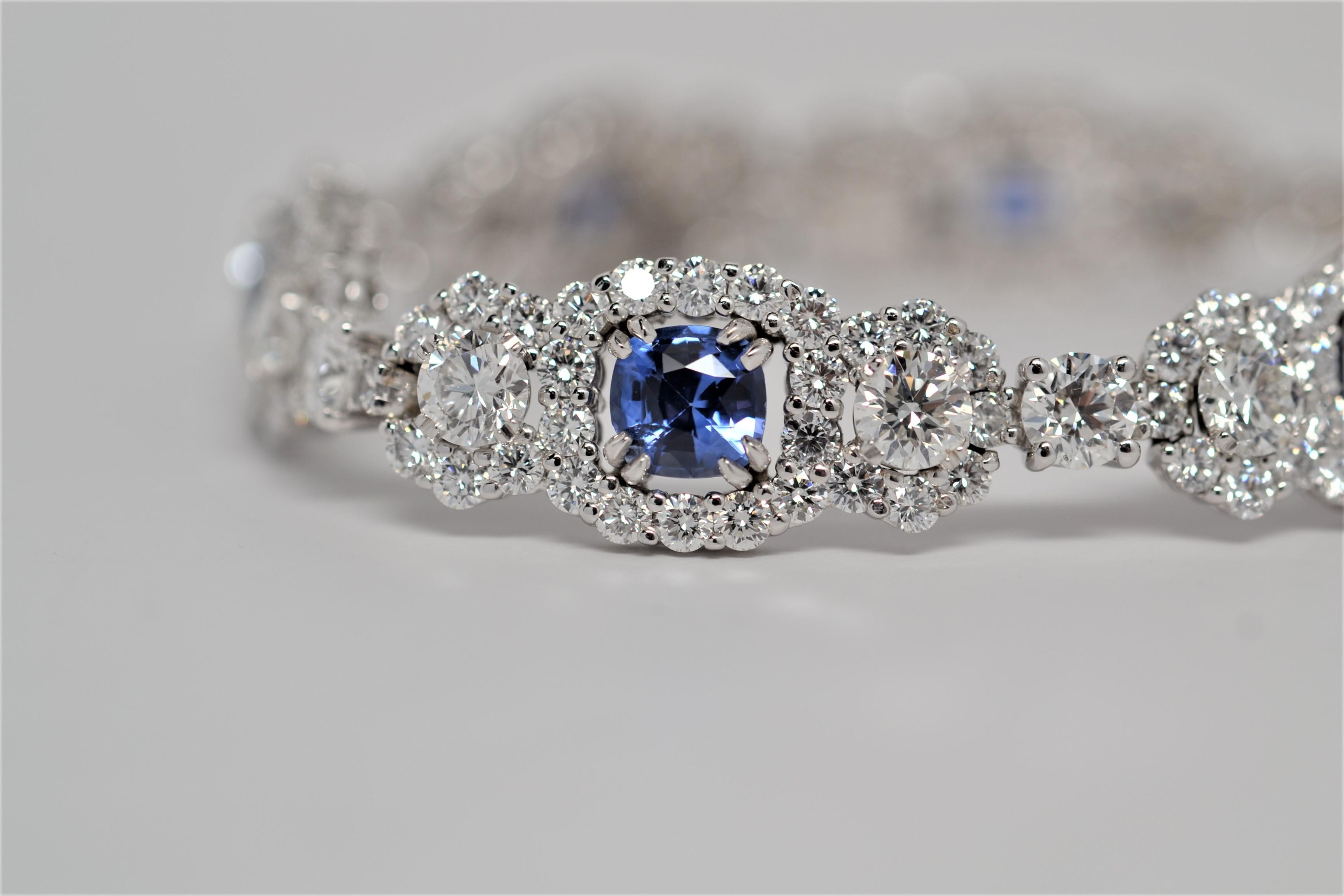 An elegant bracelet made in 18K White Gold and set with Round Brilliant Cut Blue Sapphires and Round Brilliant Cut Diamonds. 
Six Round Brilliant Cut Blue Sapphires are hand set with a double prong layout in a floating basket. The Sapphires are also