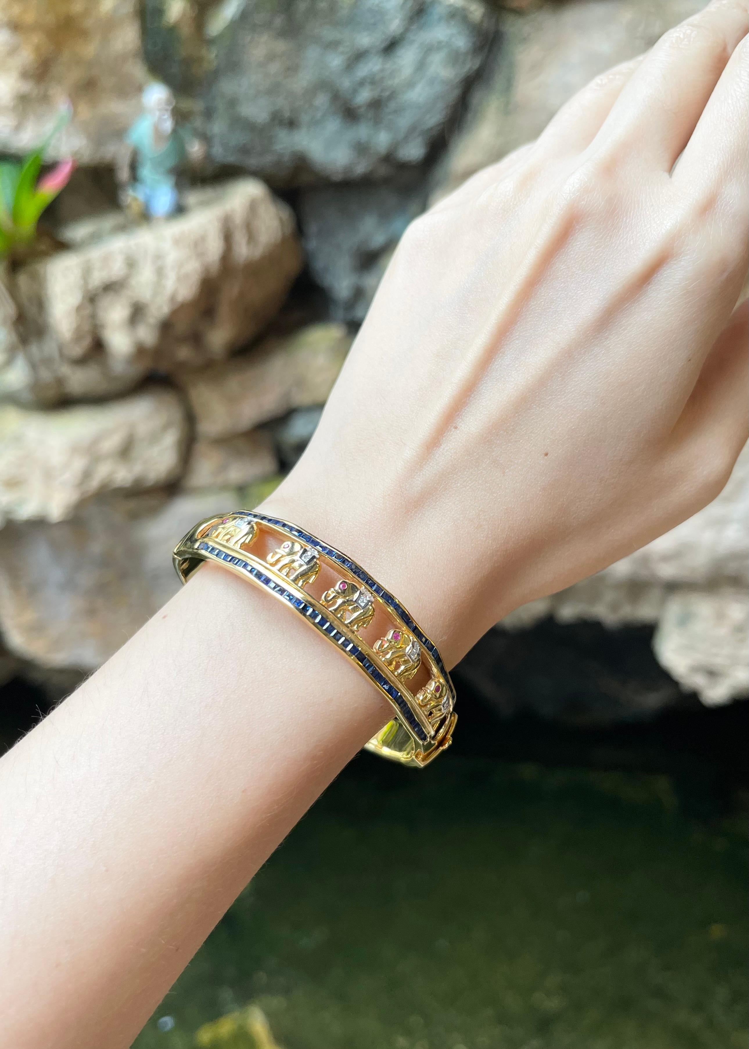 Blue Sapphire 3.63 carats, Ruby 0.15 carat and Diamond 0.17 carat Bangle set in 18K Gold Settings

Width:  1.4 cm 
Diameter: 5.8 cm
Total Weight: 33.70 grams

