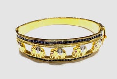 Elefantenarmreif mit blauem Saphir, Rubin 0,15 und Diamant in 18K Goldfassung