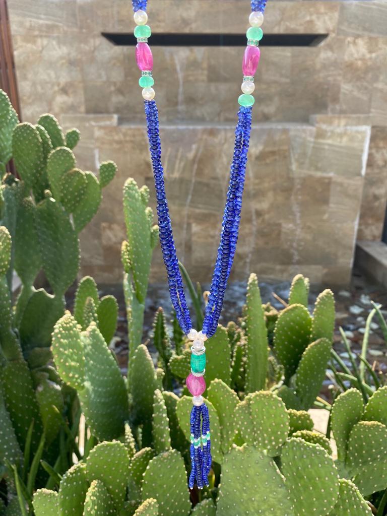 A beautiful multi-gemstone beaded necklace, with 420.30 carat Blue Sapphire, 63.80 carat Ruby, 30 carat Emeralds and Pearls. The length of the necklace is around 32 inches plus the tassel. 
We provide free shipping, and accept returns. 
Please
