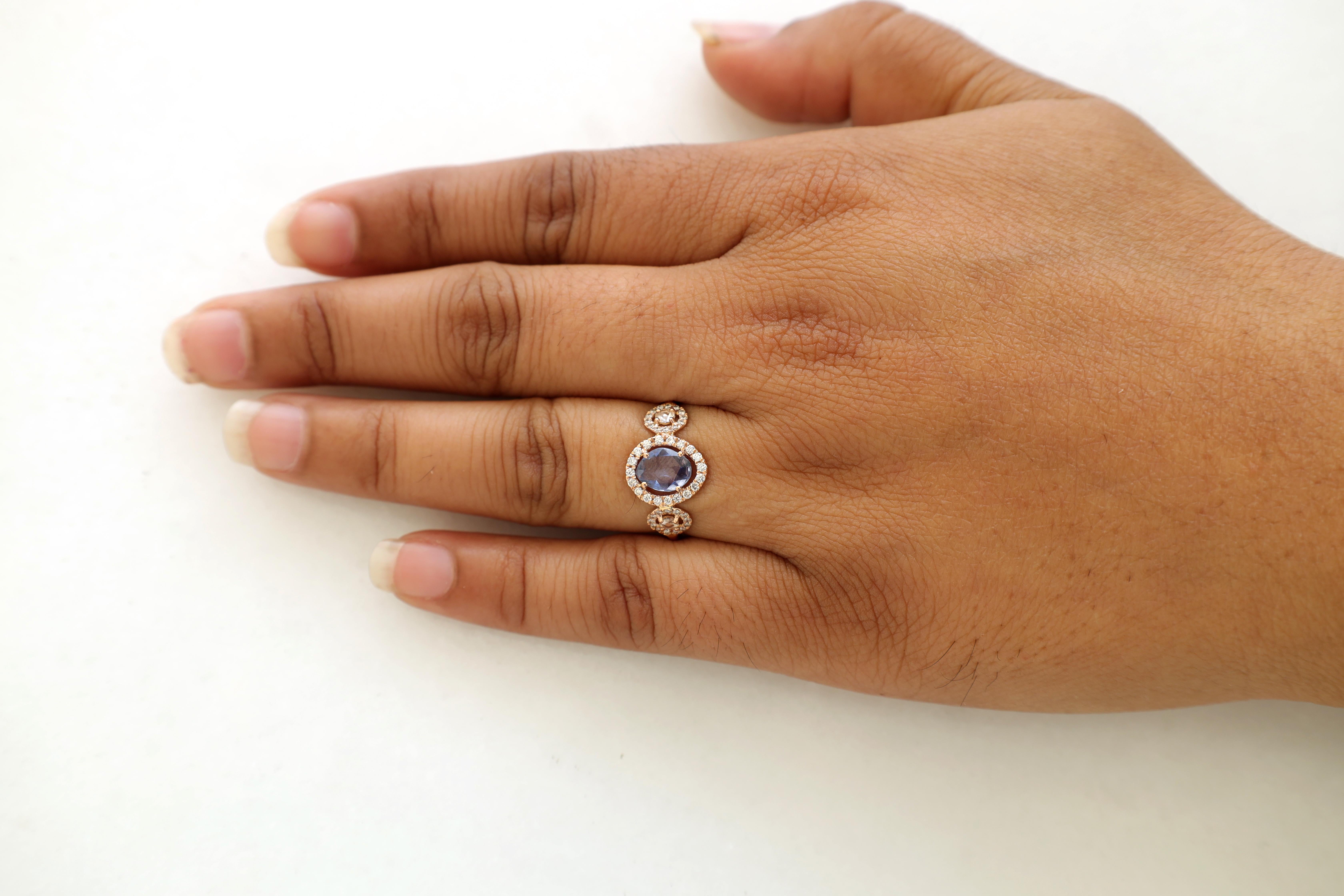 Contemporary Blue Sapphire Surrounded by Round Brilliant Cut Diamond Ring For Sale