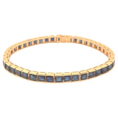 Tennisarmband aus 14 Karat Gelbgold mit blauem Saphir