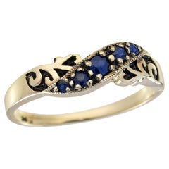 Bague courbe de style vintage en or jaune massif 9 carats avec saphir bleu