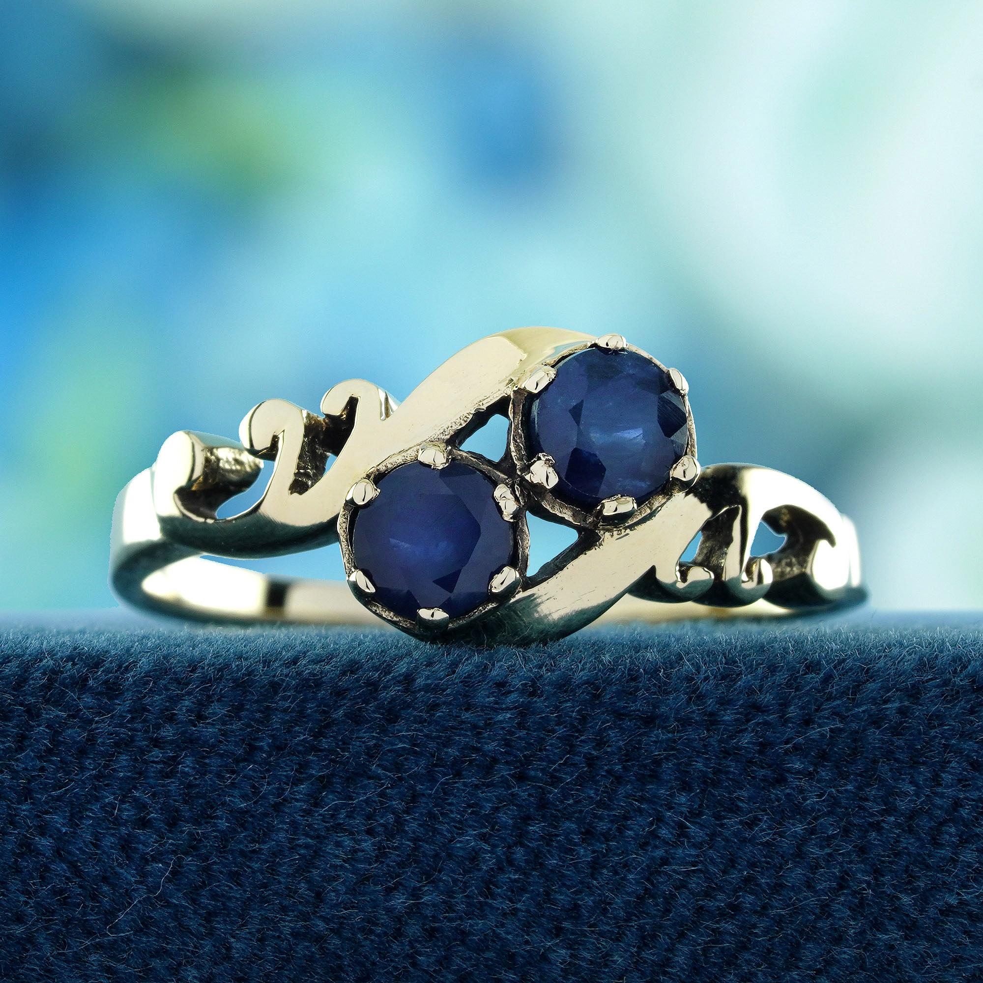 Embrace timeless sophistication with this Natural Blue Sapphire Vintage-Style Two-Stone Ring. Two dazzling sapphires, rich in deep blue hues, are gracefully set within a vintage-inspired design, symbolizing unity and everlasting love. This exquisite