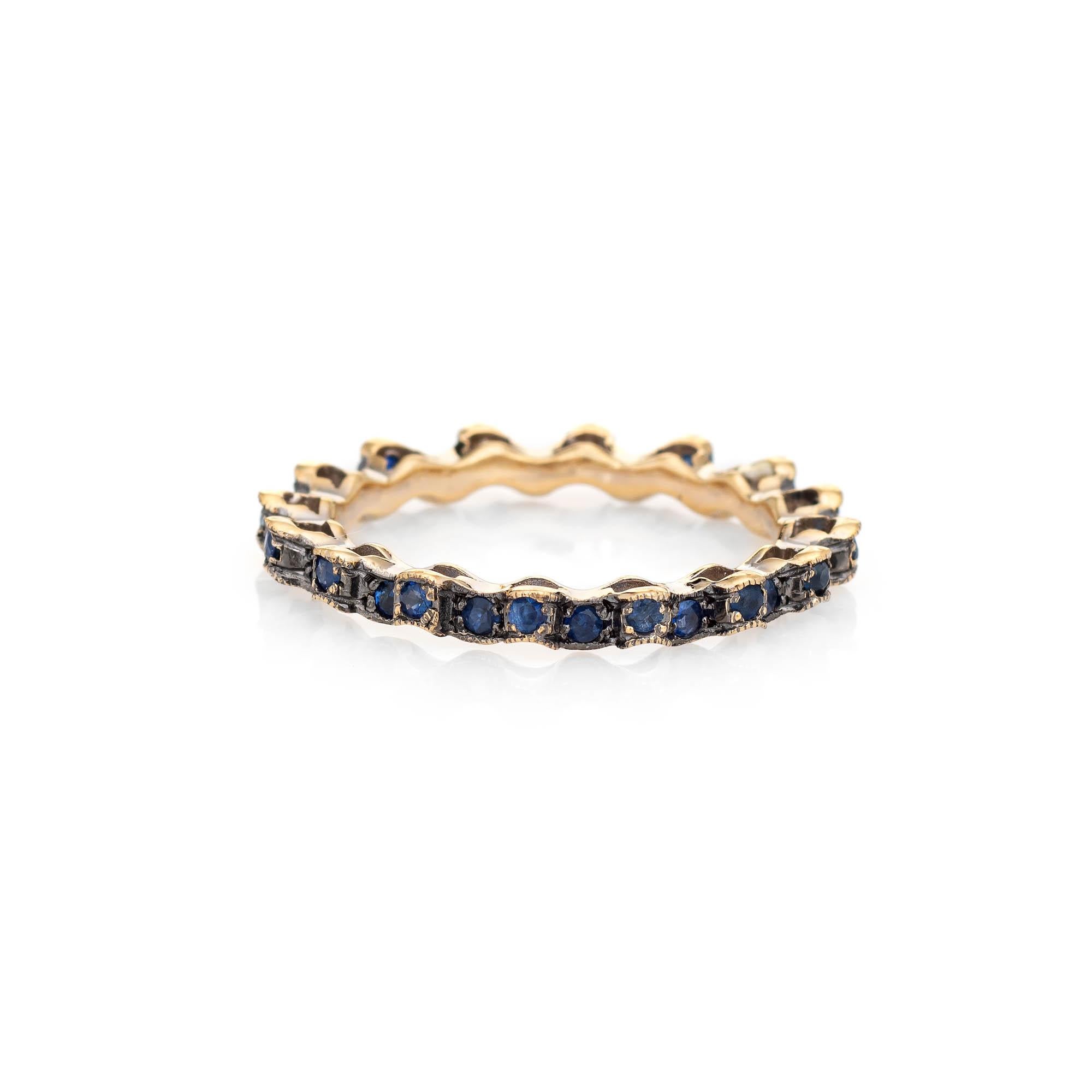 Stylish estate blue sapphire eternity ring crafted in 18 karat yellow gold. 

Blue sapphires total an estimated 0.64 carats. The sapphires are in excellent condition and free of cracks or chips. 

The unique ring features a wavy undulating design