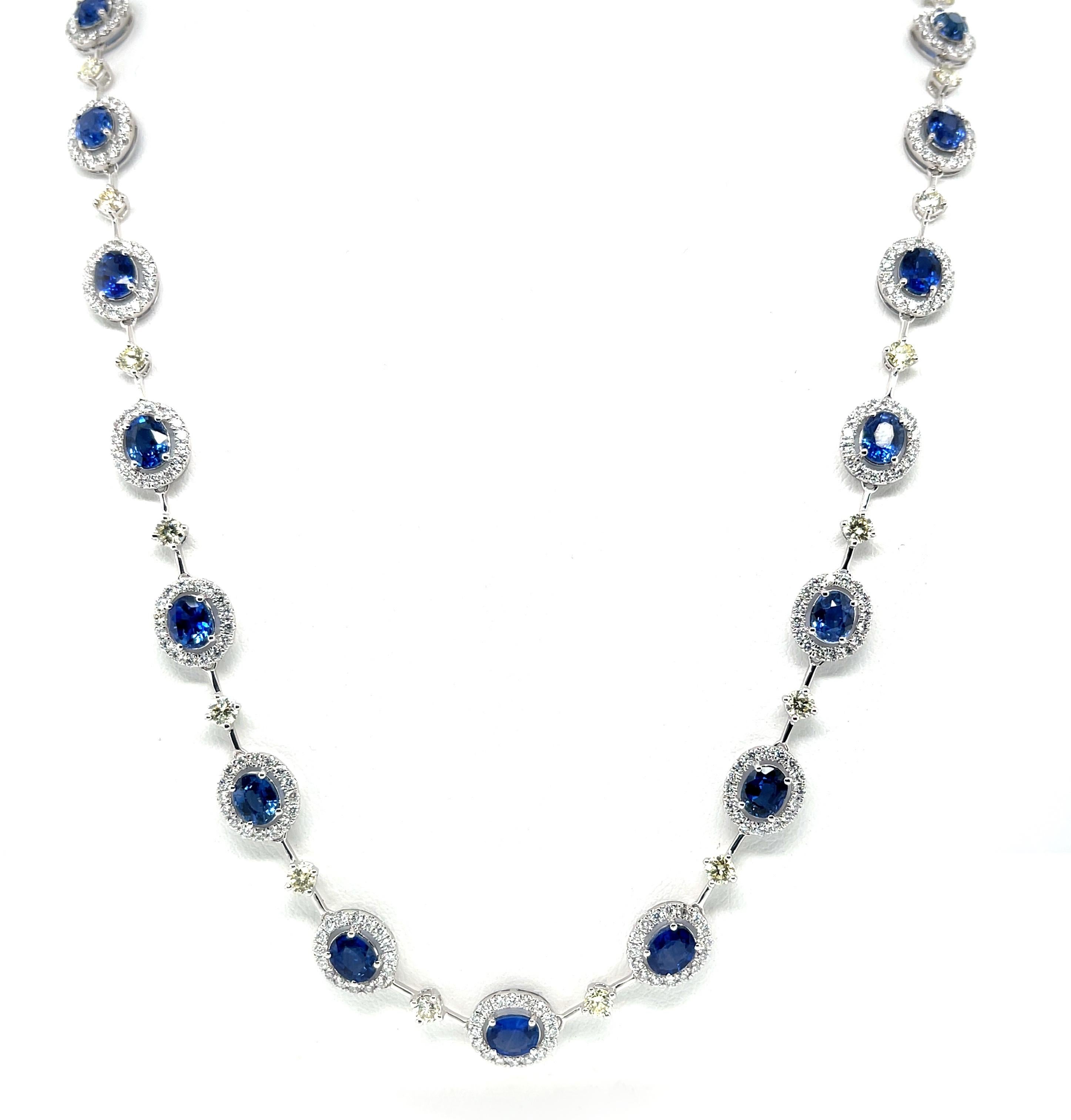 This spectacular blue sapphire and diamond Riviera necklace epitomizes luxury, class and style! The 24 beautifully matched oval sapphires weigh over 12 carats total and possess quintessential cornflower blue color that connoisseurs think of when