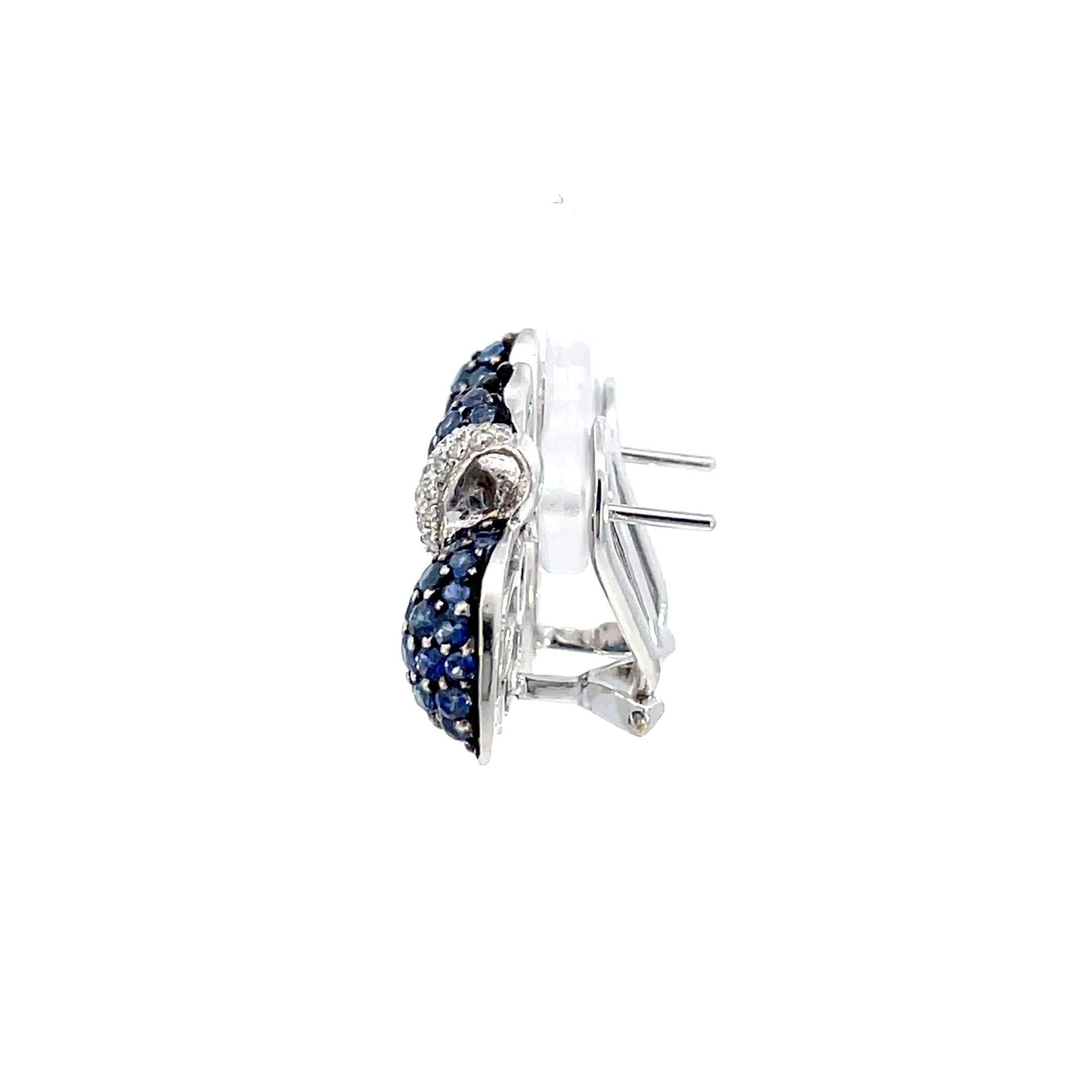 A large pair of natural blue sapphire and natural diamond earrings set in white gold highlighted with a black rhodium finish straight post and omega system.

40 Brilliant cut natural diamonds weighing 0.30ct total weight, quality G/VS

128 Natural