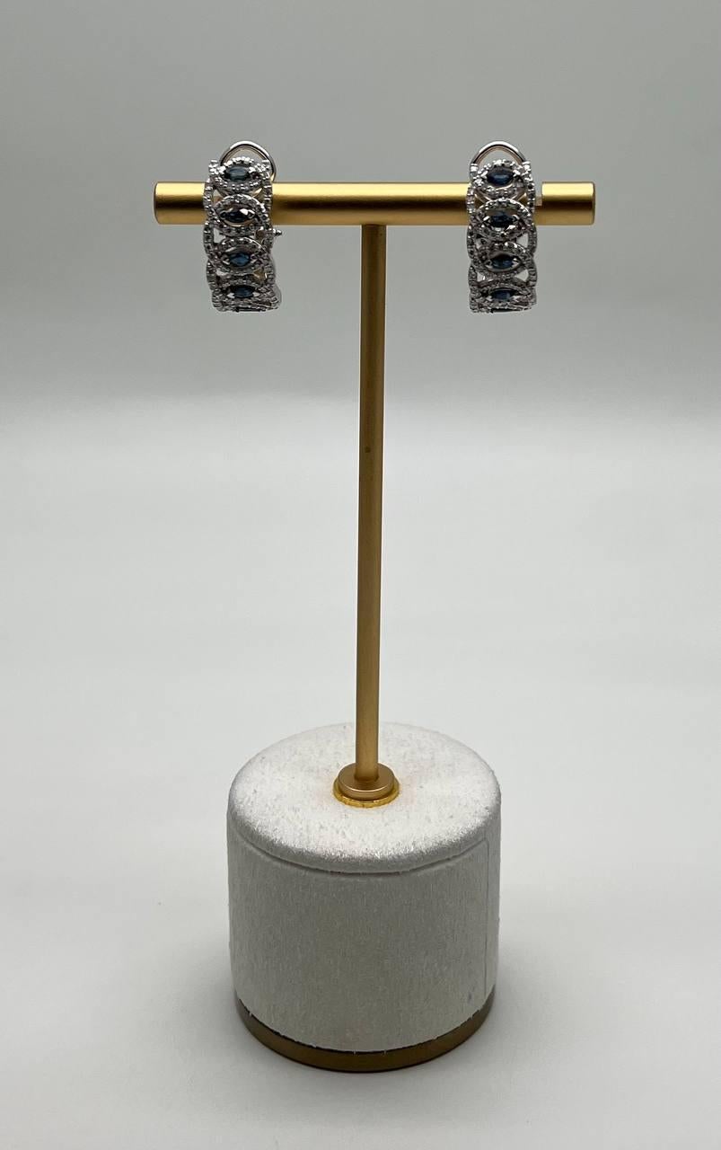 Exquisite hoop earrings - featuring a series of oval blue sapphires set in a detailed, intricate design. The stones are framed by shimmering accent diamonds, enhancing their brilliance.
14K White Gold 
0.98 CTW Diamonds 
1.14 CTW Blue Sapphires