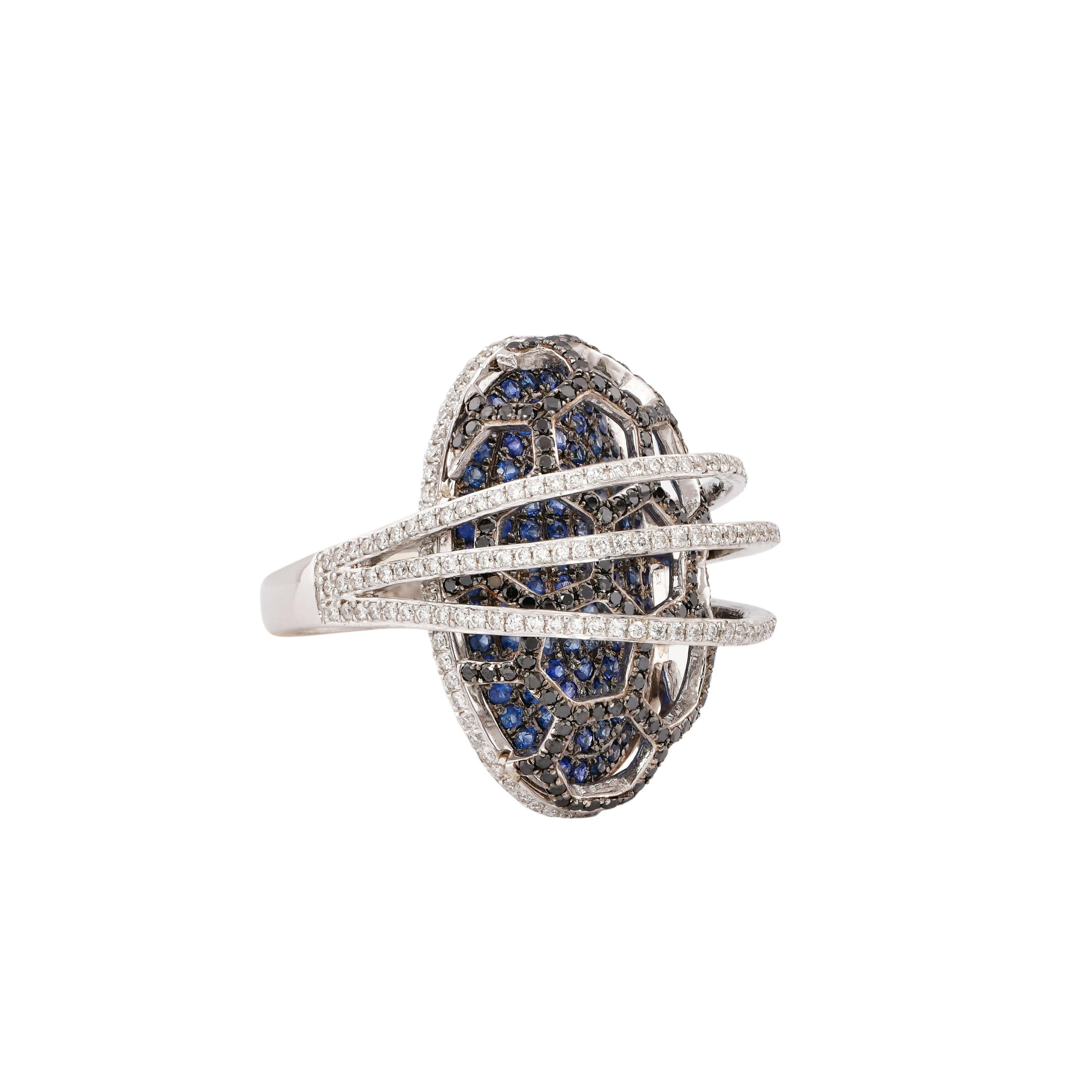 Sunita Nahata presents a collection of fancy cocktail rings with gorgeous gemstones. This ring uses a pave base of blue sapphire with an architecturally constructed black and white diamond cage on top. This unique and contrasting design presents a