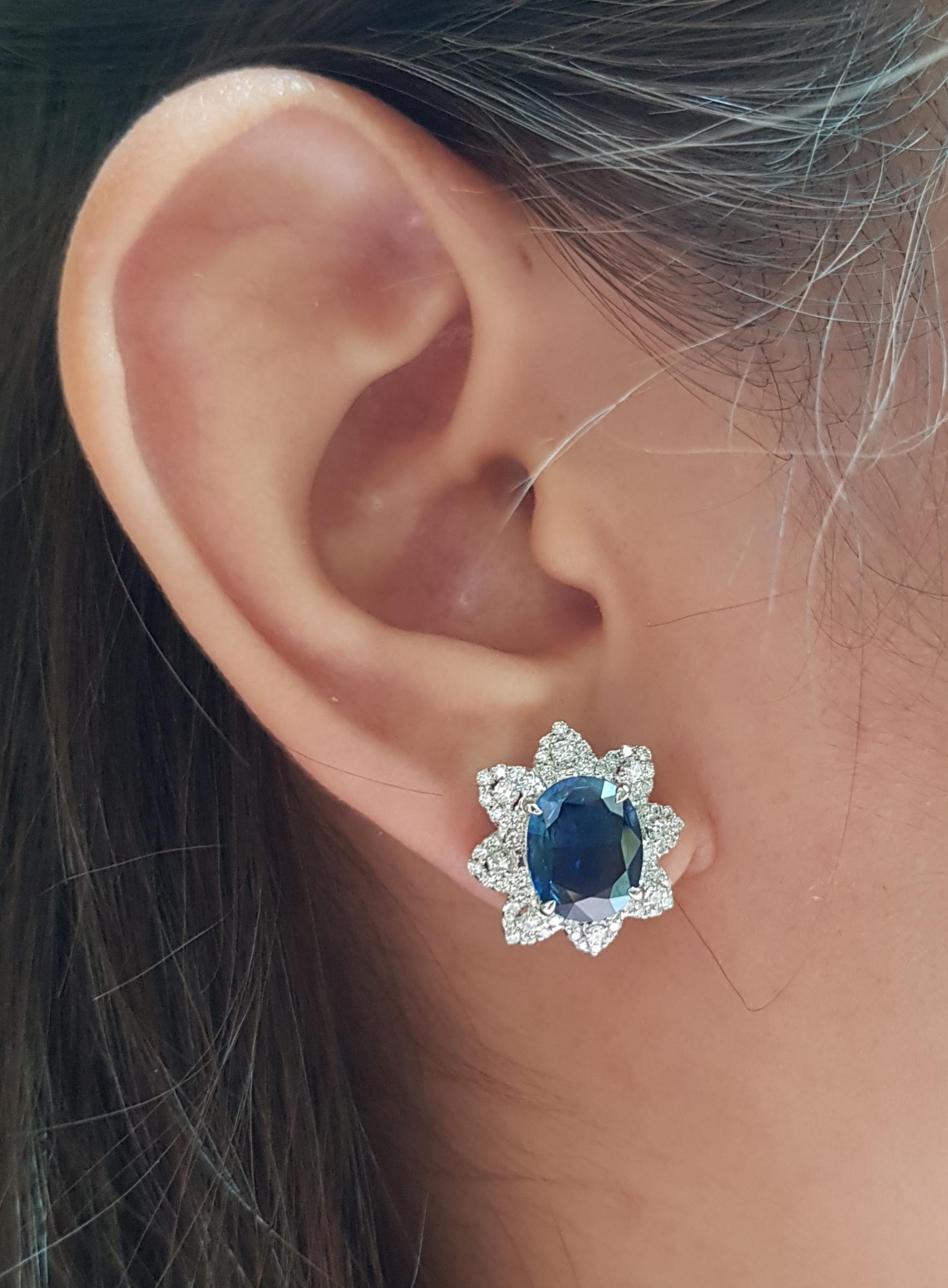 Blue Sapphire 5.57 carats with Diamond 0.88 carat Earrings set in 18 Karat White Gold Settings

Width:  1.5 cm 
Length: 1.7 cm
Total Weight: 10.46 grams

