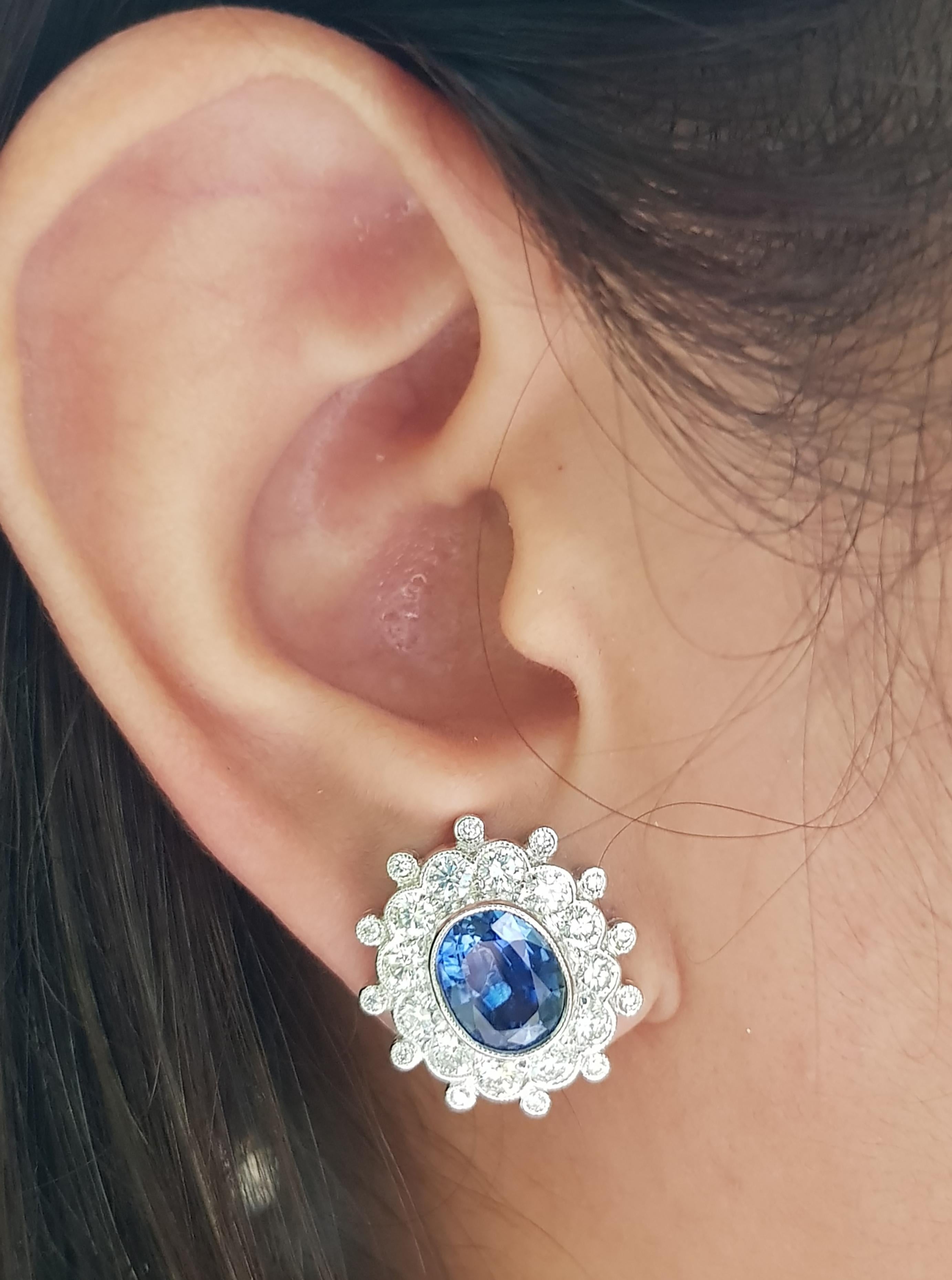 Blue Sapphire 4.55 carats with Diamond 2.06 carats Earrings set in 18 Karat White Gold Settings

Width:  1.9 cm 
Length: 1.7 cm
Total Weight: 10.11 grams

