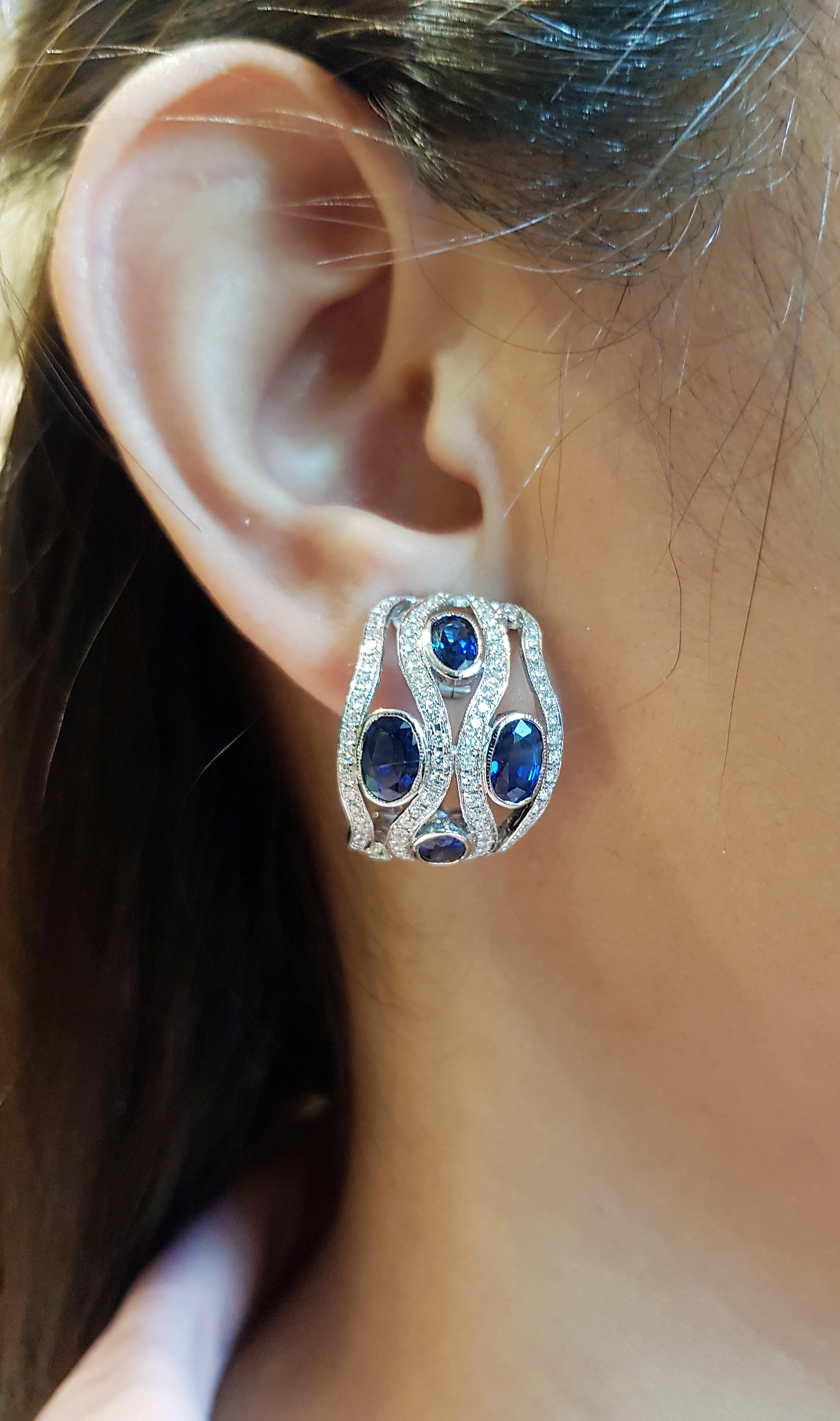 Blue Sapphire 6.0 carats with Diamond 1.66 carats Earrings set in 18 Karat White Gold Settings

Width:  1.9 cm 
Length: 2.1 cm
Total Weight: 14.4 grams

