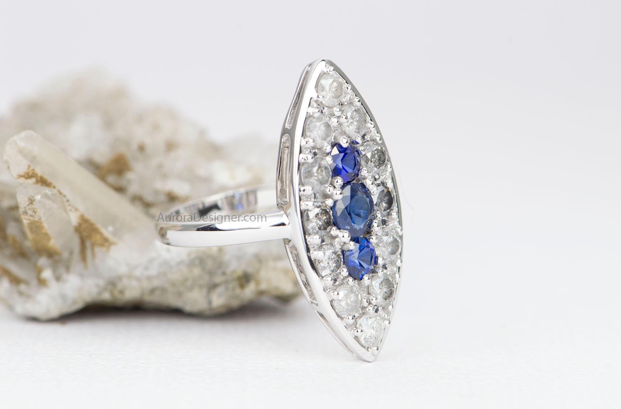♥  This is a vintage-inspired ring created in the Victorian era navette ring style
♥  Three royal blue sapphires are set in the center, then surrounded by a ring of ombrÃ© colored diamonds ranging from milky white to dark gray 
♥  True to the