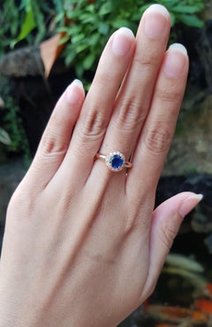 Blue Sapphire with Diamond Halo Ring Set in 18 Karat Rose Gold Settings