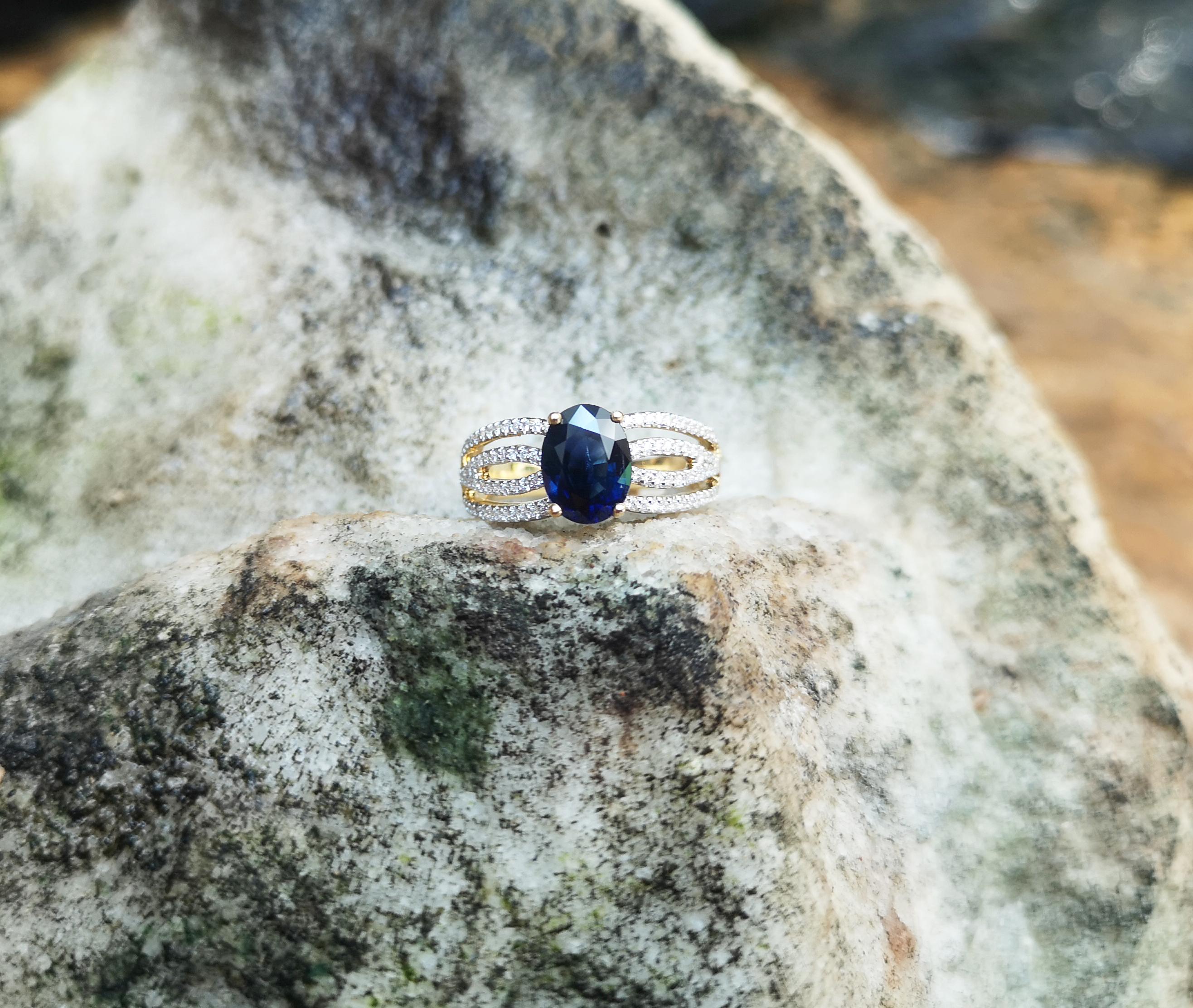 Taille ovale Bague en or 18 carats sertie d'un saphir bleu et de diamants en vente