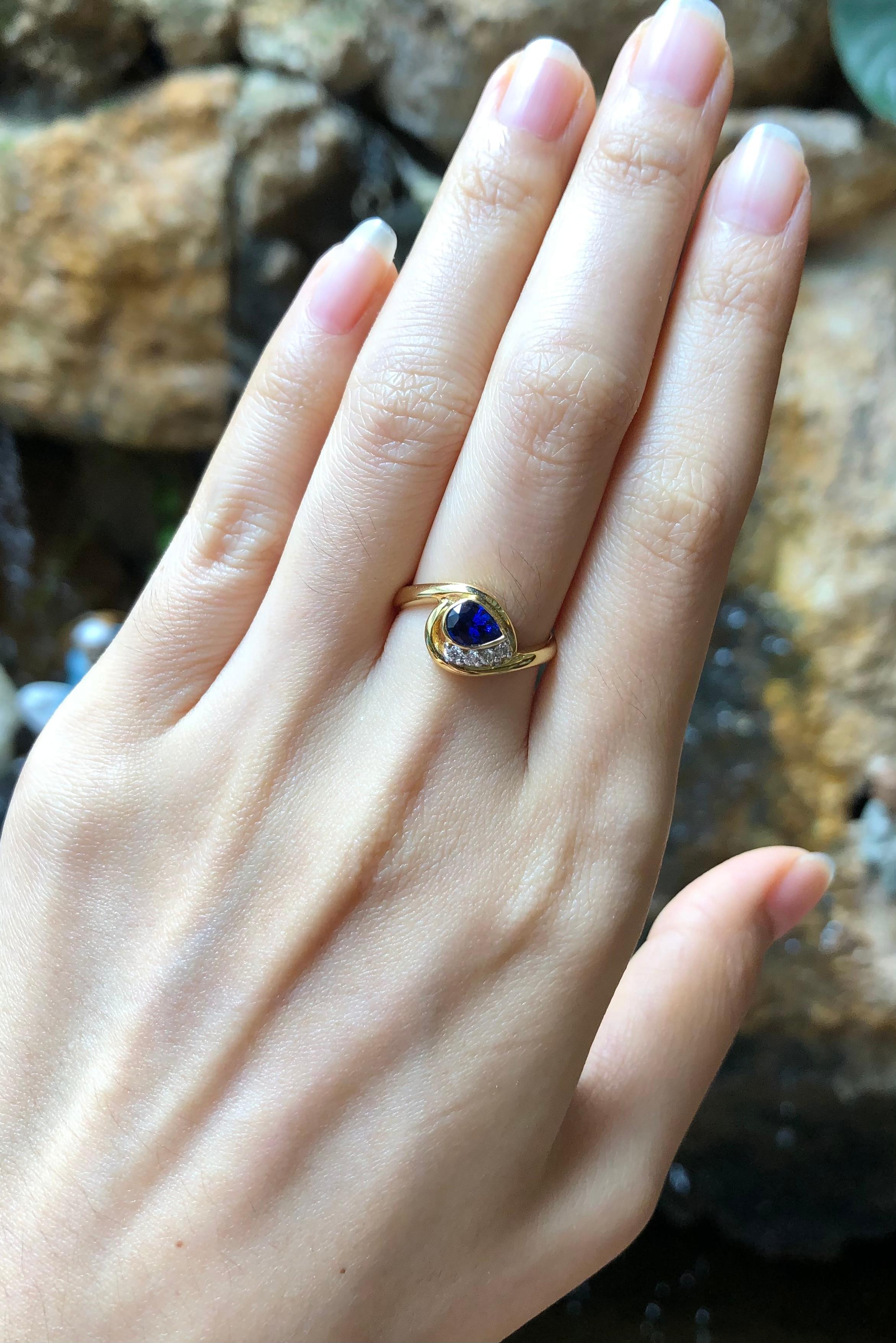 Pear Cut Blue Sapphire with Diamond Ring Set in 18 Karat Gold Settings For Sale