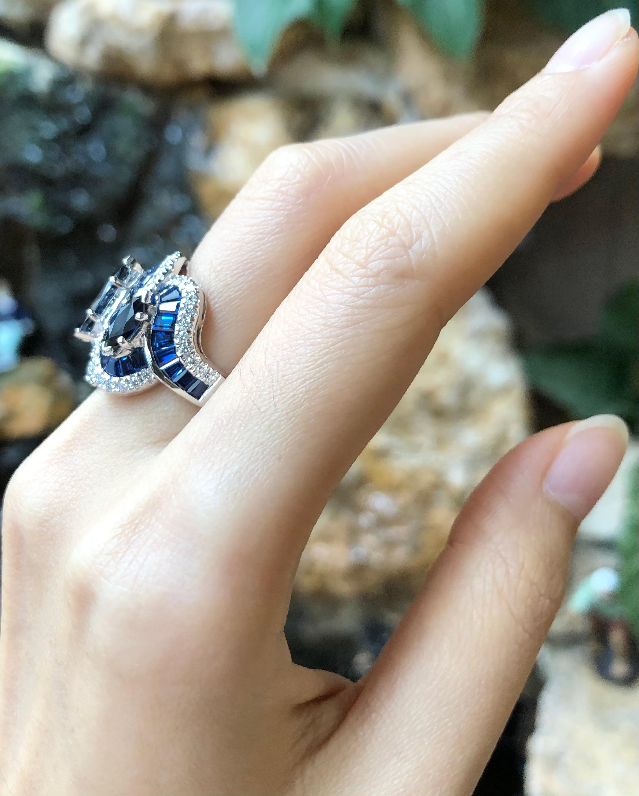 Blue Sapphire 1.93 carats (Center Marquise) with Blue Sapphire 1.55 cts (Total Side Marquises) with Sapphire 7.92 carats (Total Baguette) and Diamond 0.57 carat Ring set in 18 Karat White Gold Settings

Width:  2.0 cm 
Length:  2.0 cm
Ring Size: