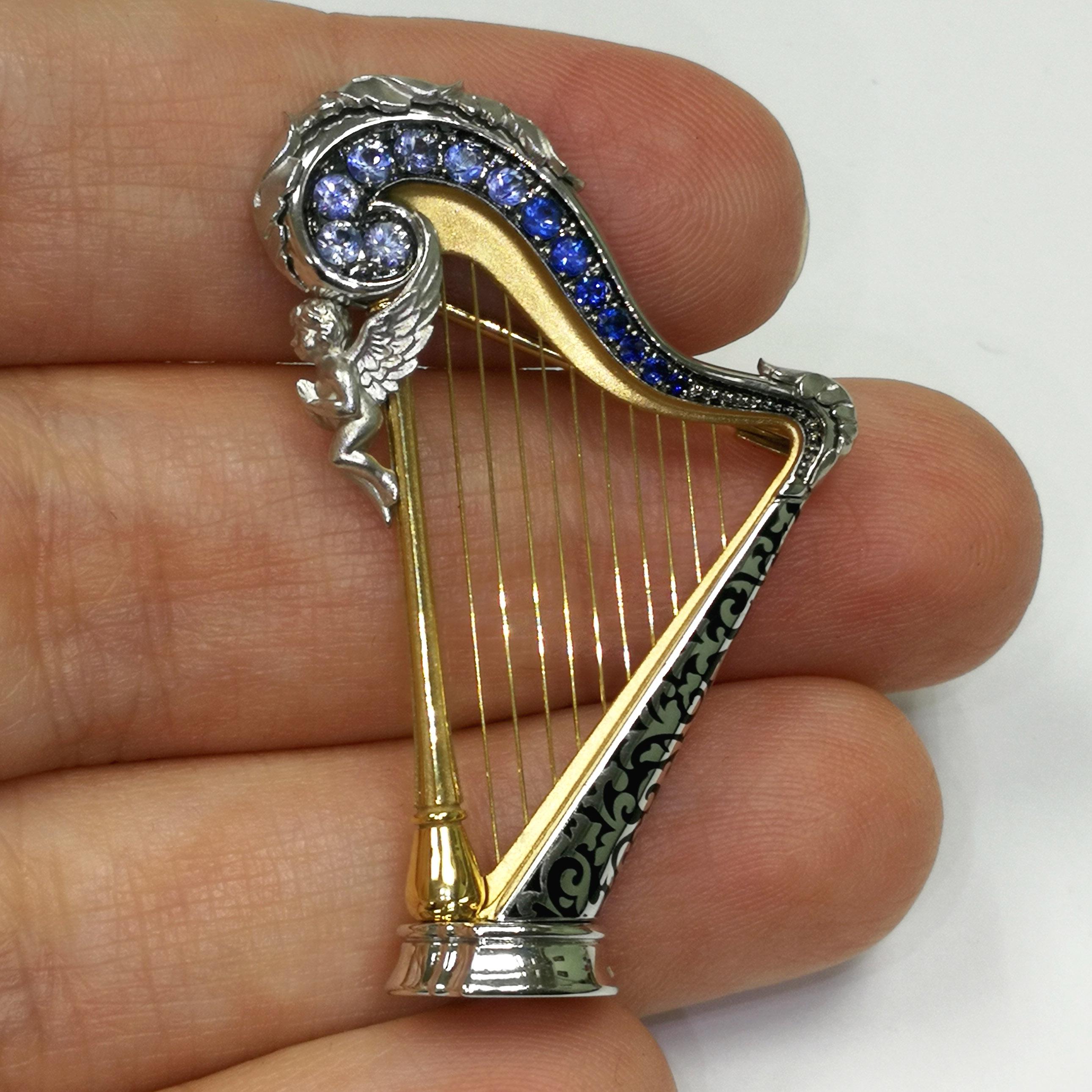 Blue Sapphires 18 Karat White Gold Harp Brooch
Harps were widely used in the ancient Mediterranean and Middle East, although rare in Greece and Rome; depictions survive from Egypt and Mesopotamia from about 3000 BCE. 
Thanks to its “universal