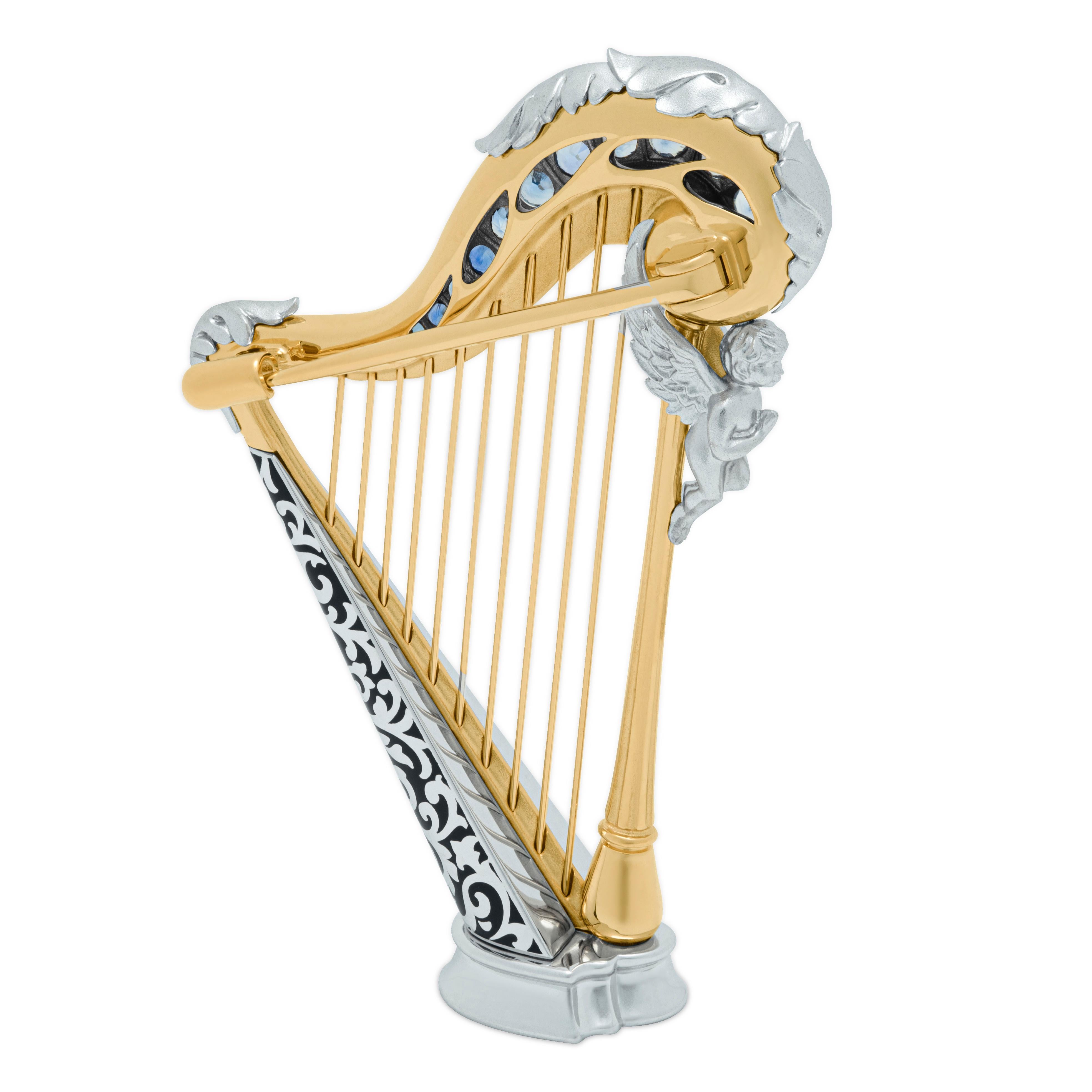 Blue Sapphires 18 Karat White Yellow Gold Harp Brooch
Harps were widely used in the ancient Mediterranean and Middle East, although rare in Greece and Rome; depictions survive from Egypt and Mesopotamia from about 3000 BCE. 
Thanks to its “universal