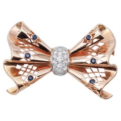 Blue Sapphires, Diamonds, 18 Karat Rose and White Gold Ribbon Shape Brooch