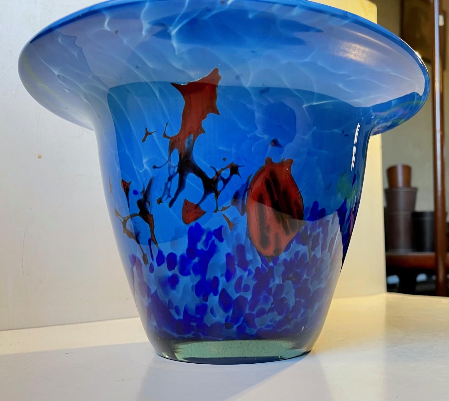 A large hat-shaped hand blown art glass bowl. Decorated in different colors with blister-technique. It was made in Scandinavia during the 1970s, probably by Kosta Boda in Sweden. The style is reminiscent of Bertil Vallien. Measurements: deep: 28 cm,