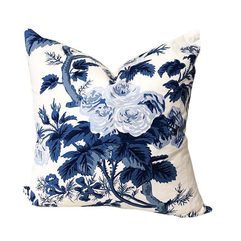 One large blue and white floral pillow. Fabric is in Schumacher's Blue Pyne Hollyhock. Down-filled with knife edge and zipper. Removable Cover. Back is plain cream white. The pattern on each pillow varies due to the repeat on the fabric. Chinoiserie