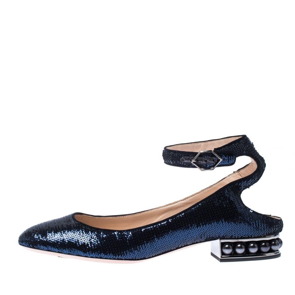 These Lola sandals from Nicholas Kirkwood are simply irresistible. The gorgeous blue sandals are decked with sequins and feature a round toe silhouette with artistic cutouts at the counters. They flaunt buckled straps at the ankles and low heels