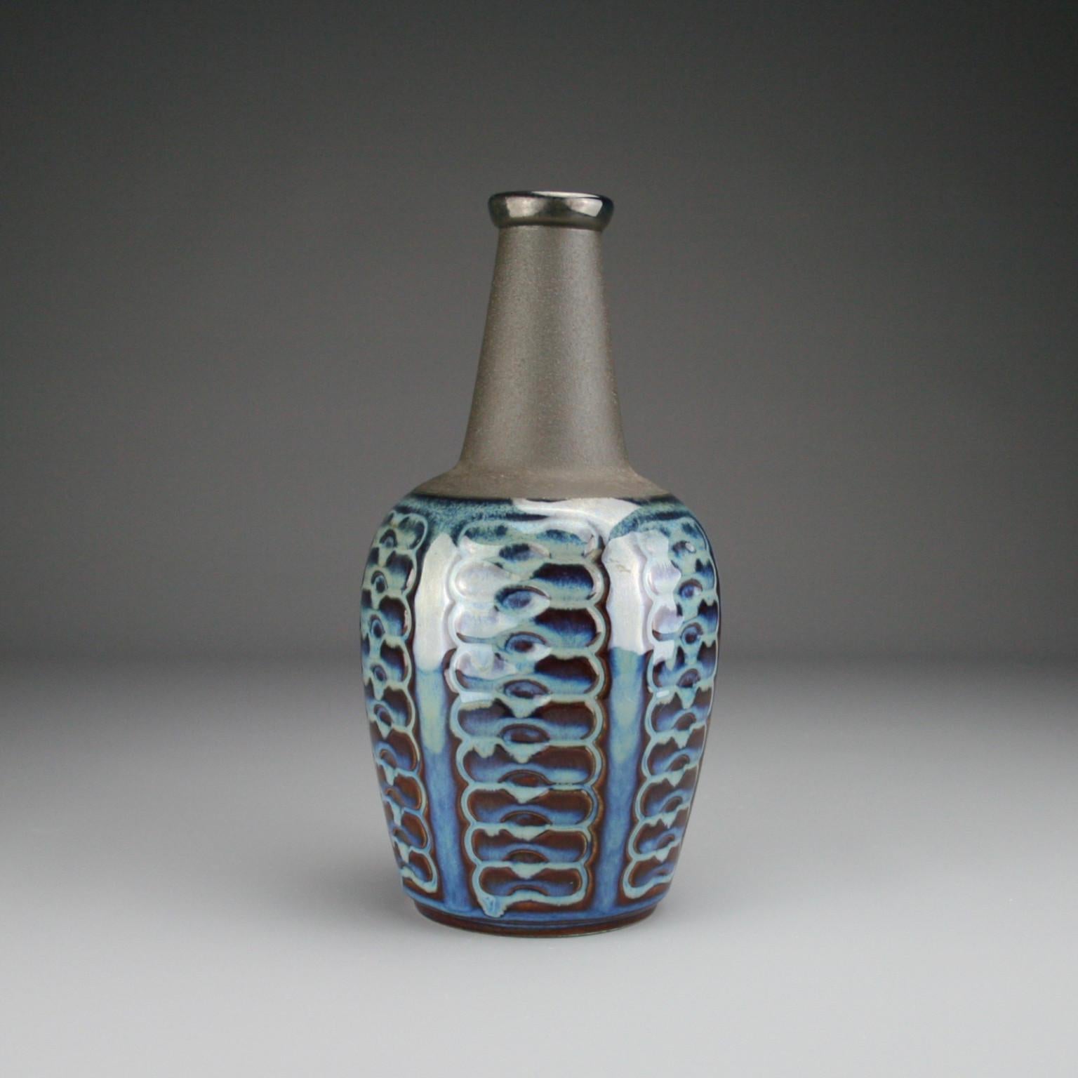 This vase is by Danish ceramicist Einar Johansen and is from his well known “blue series” which are highly sought after today among collectors. Born in 1906, Einar Johansen was a Danish ceramicist, who trained as a painter at the Royal Danish