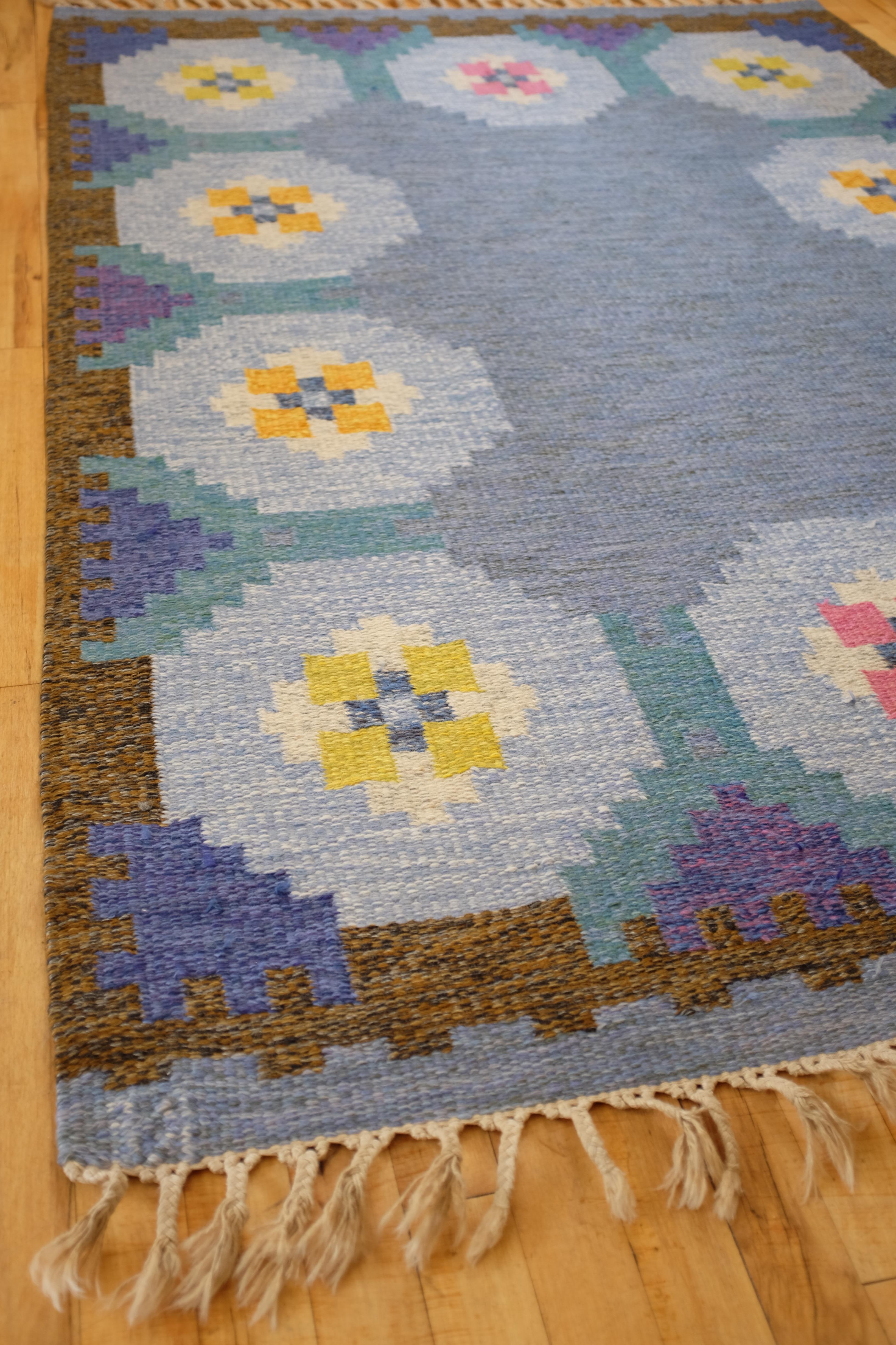 Beautiful Blue shaded Vintage Swedish rug with accent colors in brown, pink yellow and orange in a geometric design. Good vintage condition with age appropriate wear to the fringes and some small marks throughout the rug.

Dimensions: L 80.5 in x W