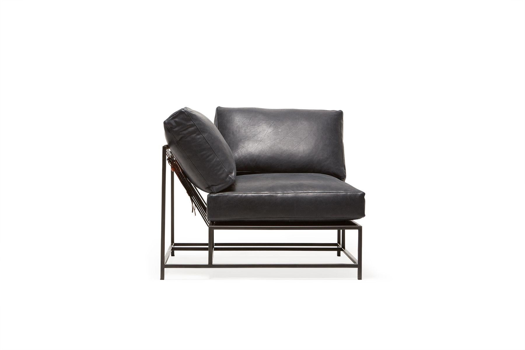 The inheritance corner chair can be used as a standalone piece, or as part of a modular sectional with other inheritance pieces.
This variation is upholstered in a dark blue smoke leather. The foam seat cushions have been wrapped in down, allowing