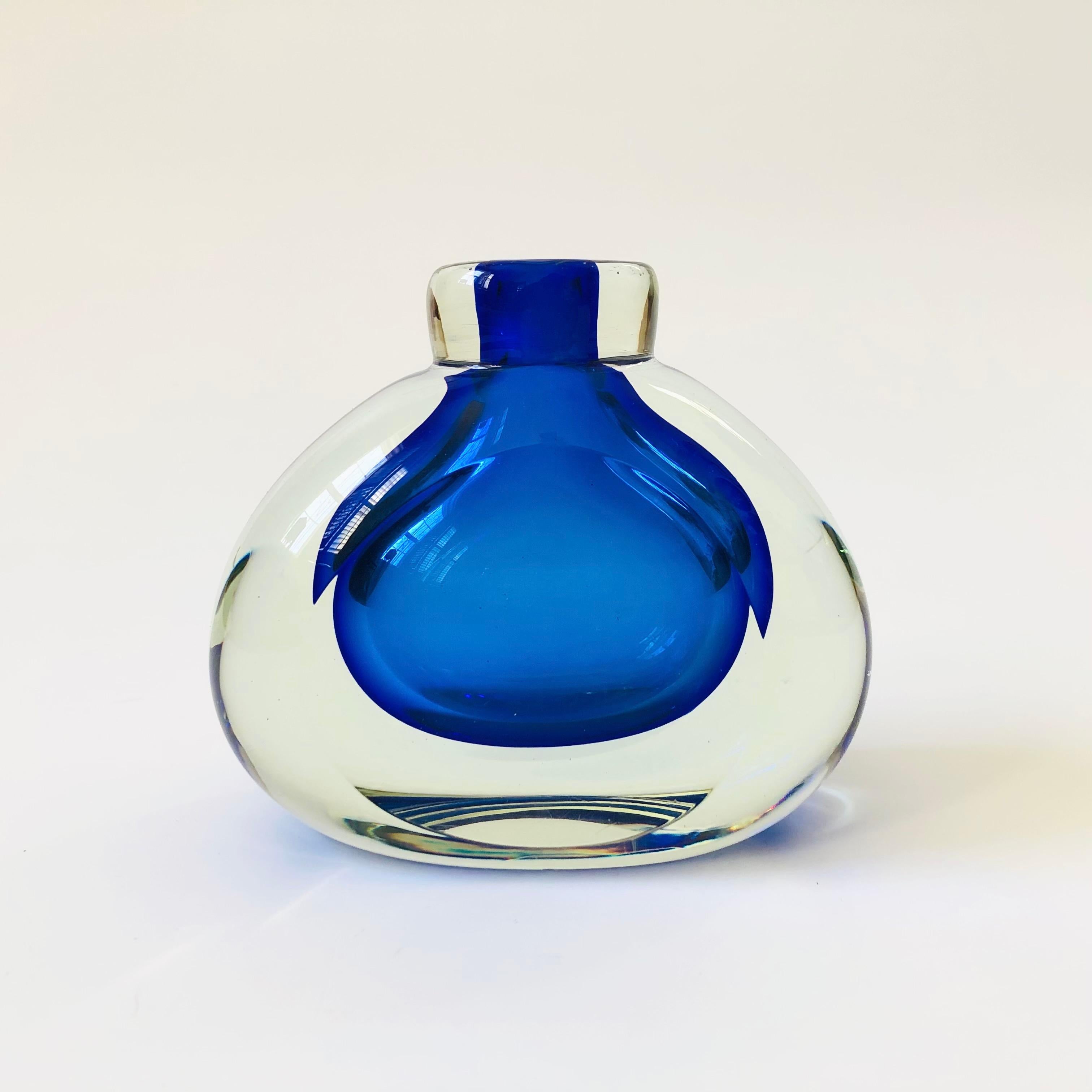 Un magnifique vase vintage en verre d'art de style sommerso. Le verre intérieur bleu cobalt vibrant est entouré d'un verre extérieur épais et transparent. Côtés aplatis. Une belle pièce d'accent sculpturale.

