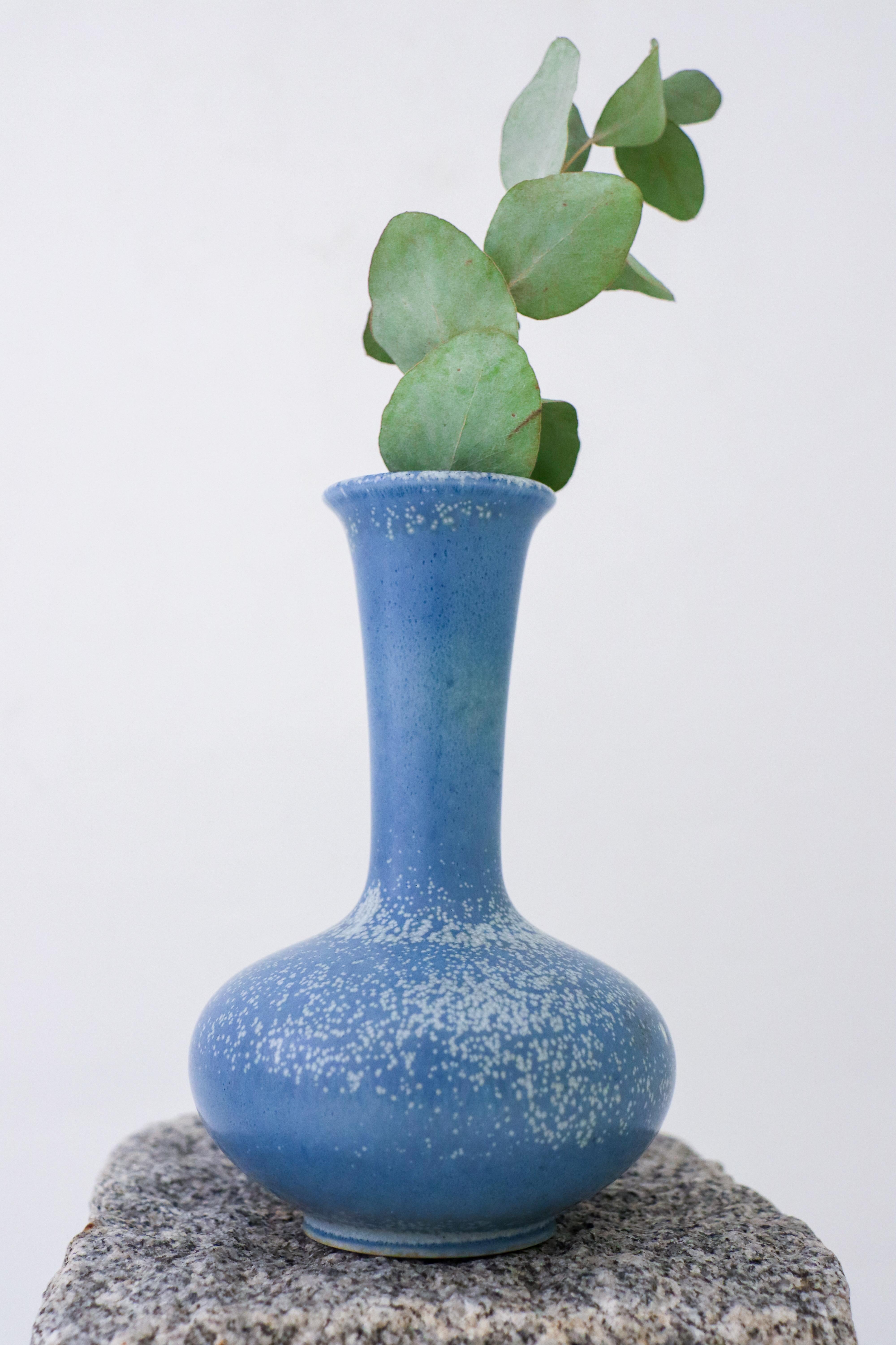 A blue speckled ceramic vase designed by Gunnar Nylund at Rörstrand. It is 16 cm (6.4