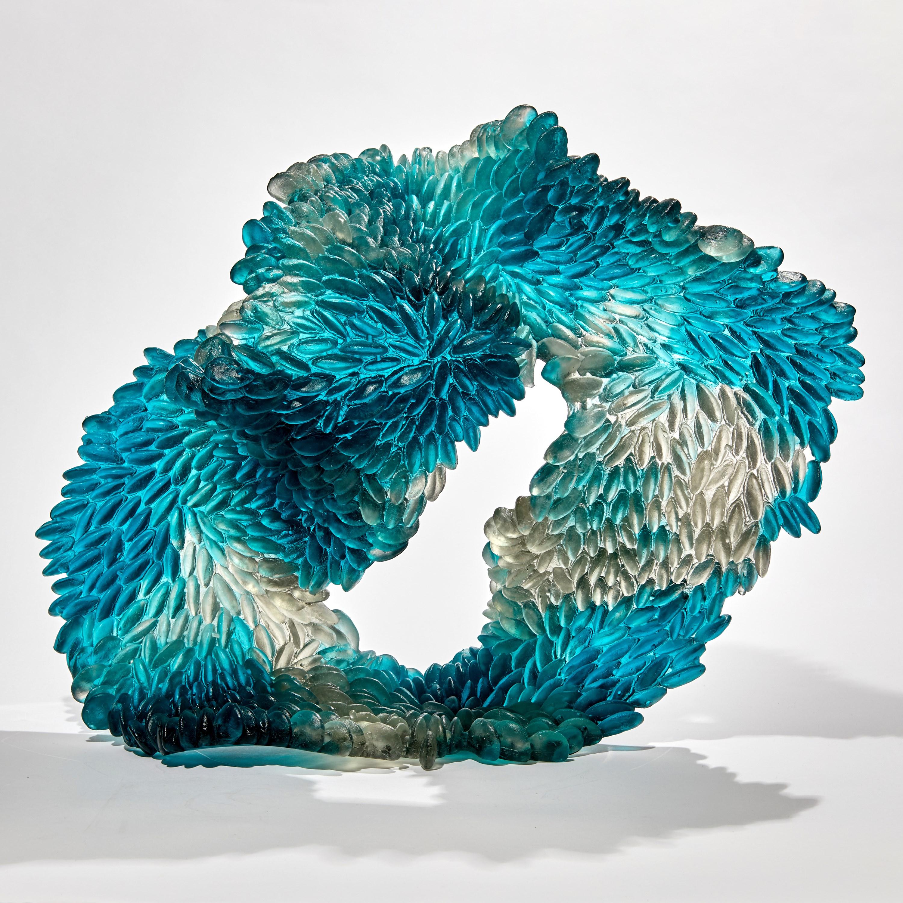 Blue Stain is a unique textured glass sculpture in teal blue and grey by the British artist Nina Casson McGarva.

Casson McGarva firstly casts her glass in a flat mould where she introduces all of the beautifully detailed, scaled surface texture,