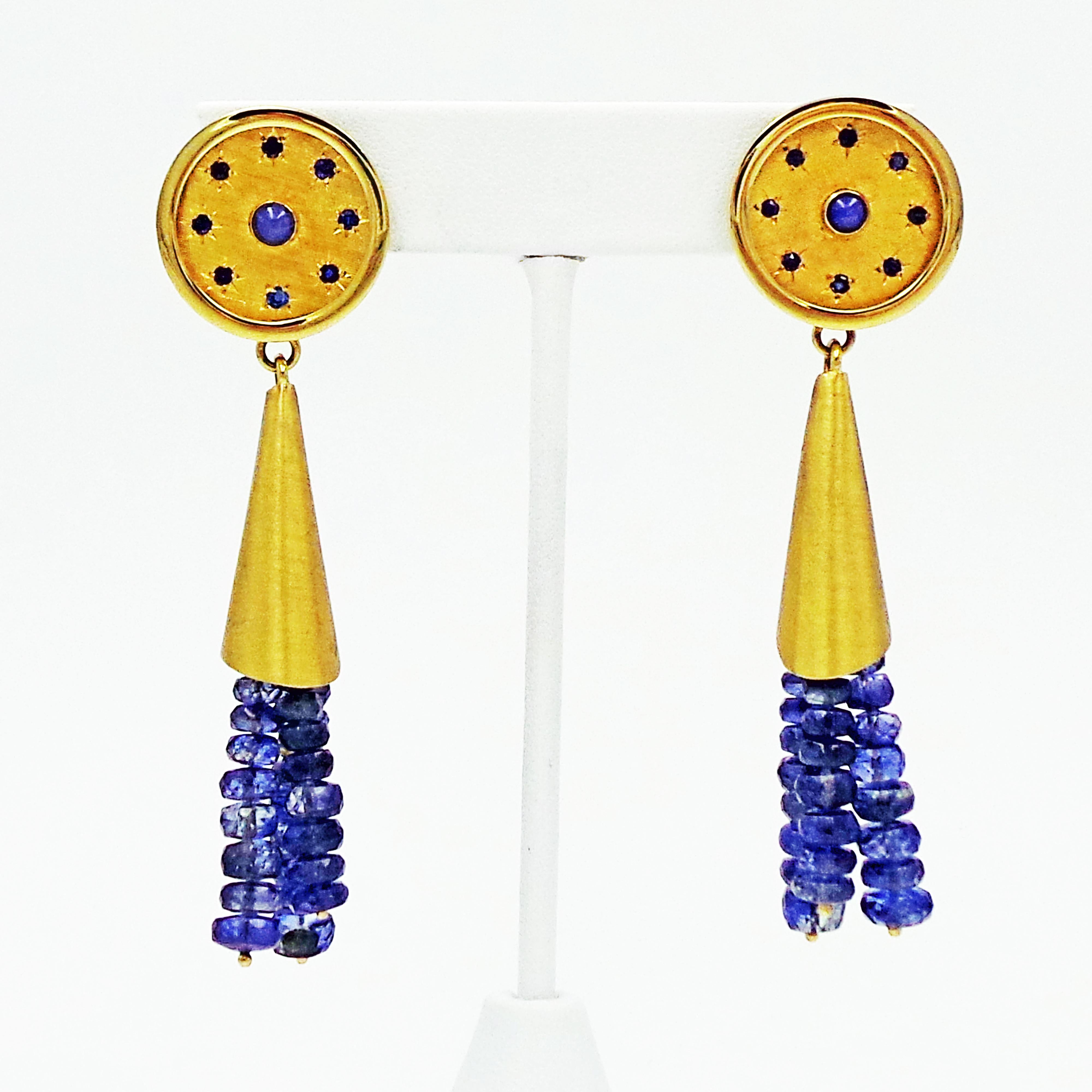 Gorgeous, vintage 14k yellow gold disc with Star Sapphire cabochon surrounded by eight faceted blue Sapphires, and attached to a 14k gold cone with Kyanite beaded tassel. The earrings have stud posts with hinged safety clasps for added security. 