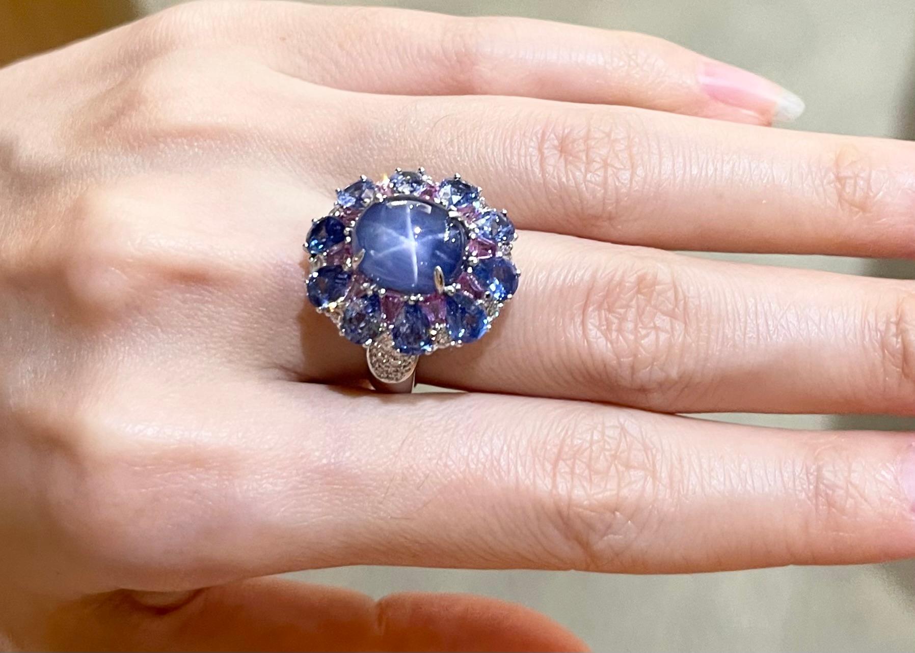 Blue Star Sapphire 10.68 carats, Blue Sapphire 4.06 carats, Pink Sapphire 2.0 carats and Diamond 0.74 carats Ring set in 18K White Gold Settings

Width:  2.0 cm 
Length: 2.2 cm
Ring Size: 54
Total Weight: 10.13 grams

