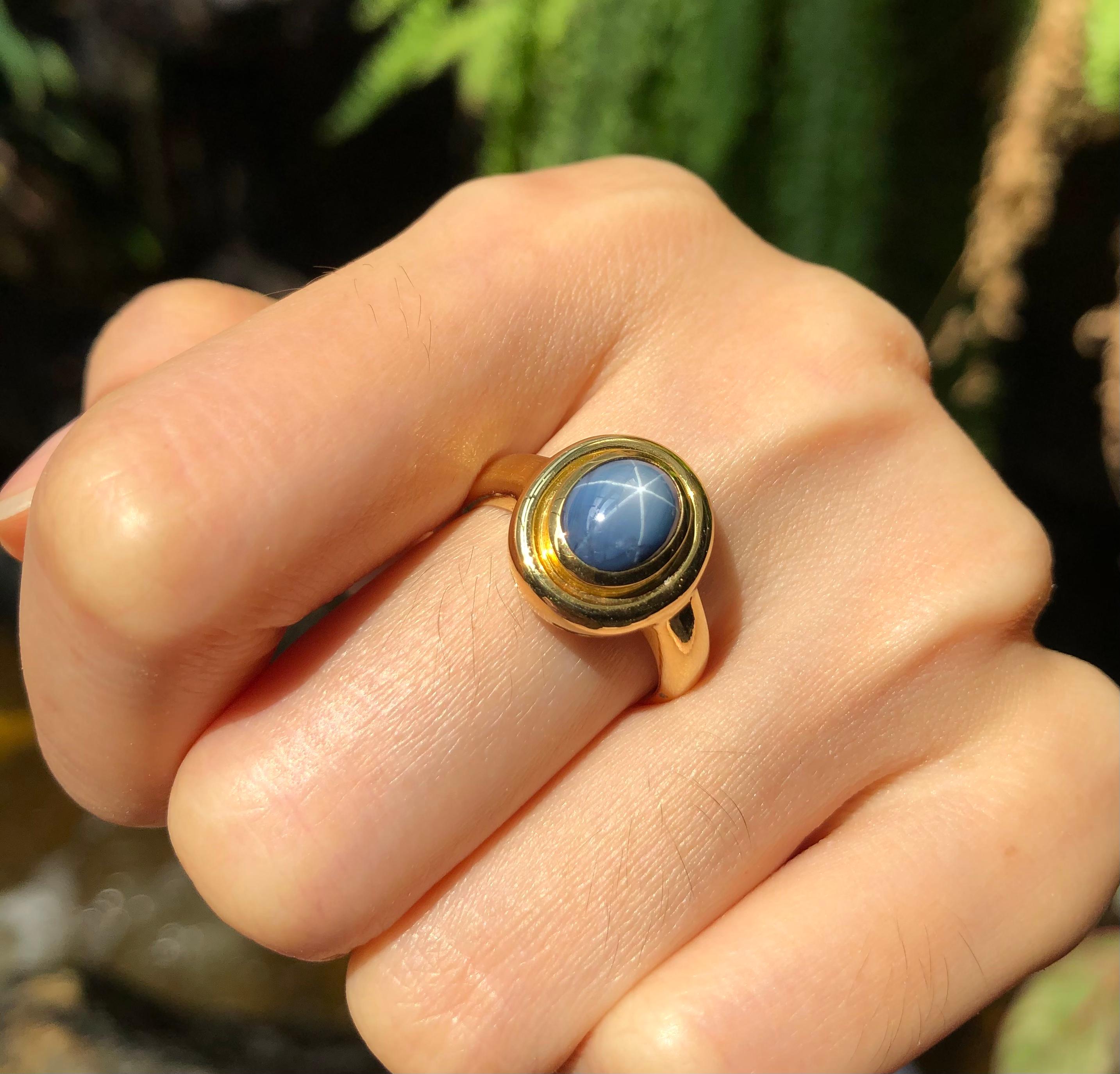 Contemporary Blue Star Sapphire Ring Set in 18 Karat Gold Settings