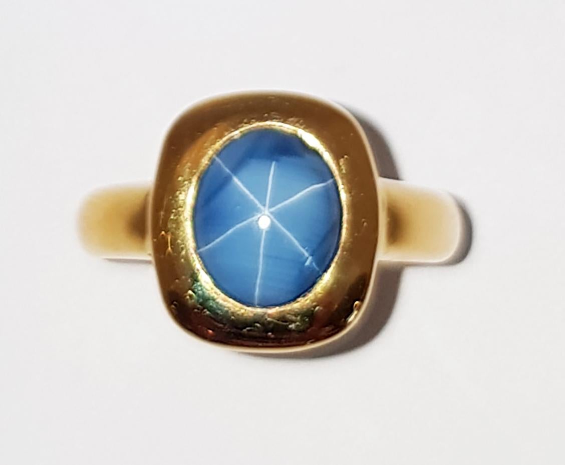 Women's Blue Star Sapphire Ring Set in 18 Karat Gold Settings For Sale