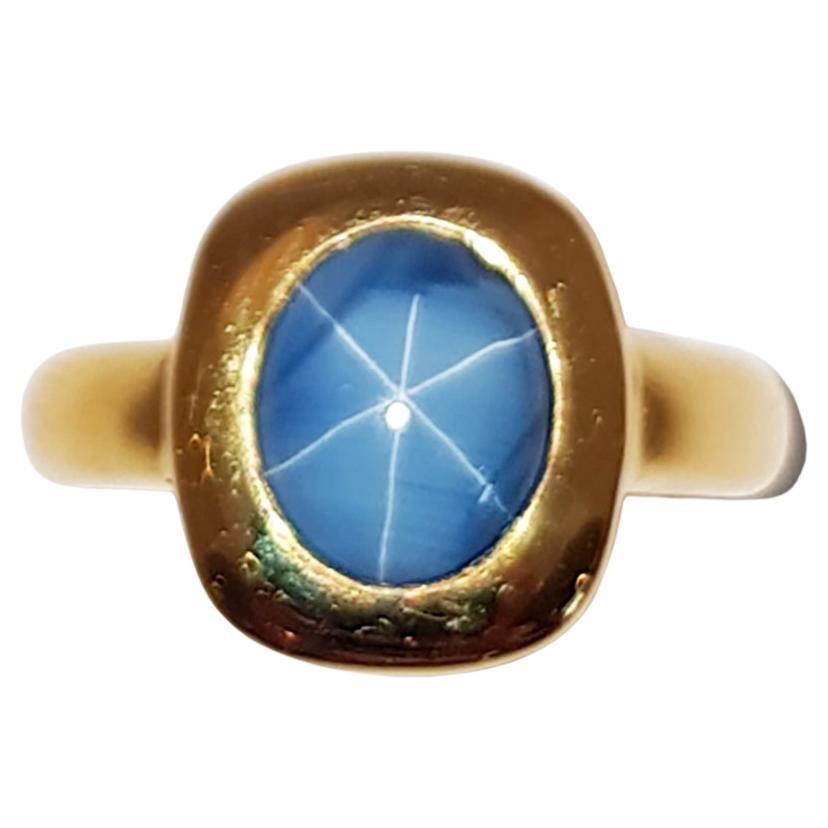 Blue Star Sapphire Ring Set in 18 Karat Gold Settings For Sale