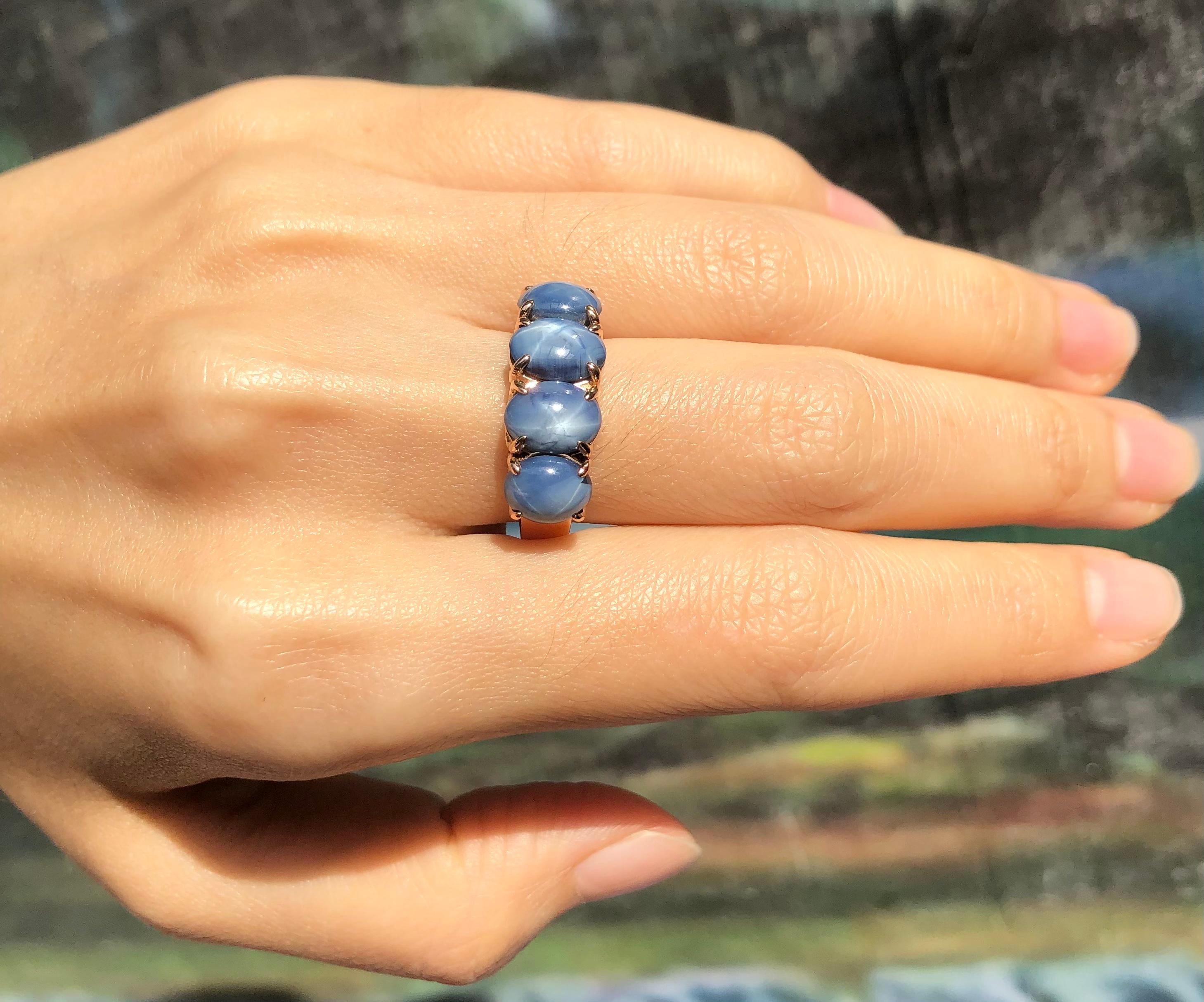 Contemporary Blue Star Sapphire Ring Set in 18 Karat Rose Gold Settings For Sale