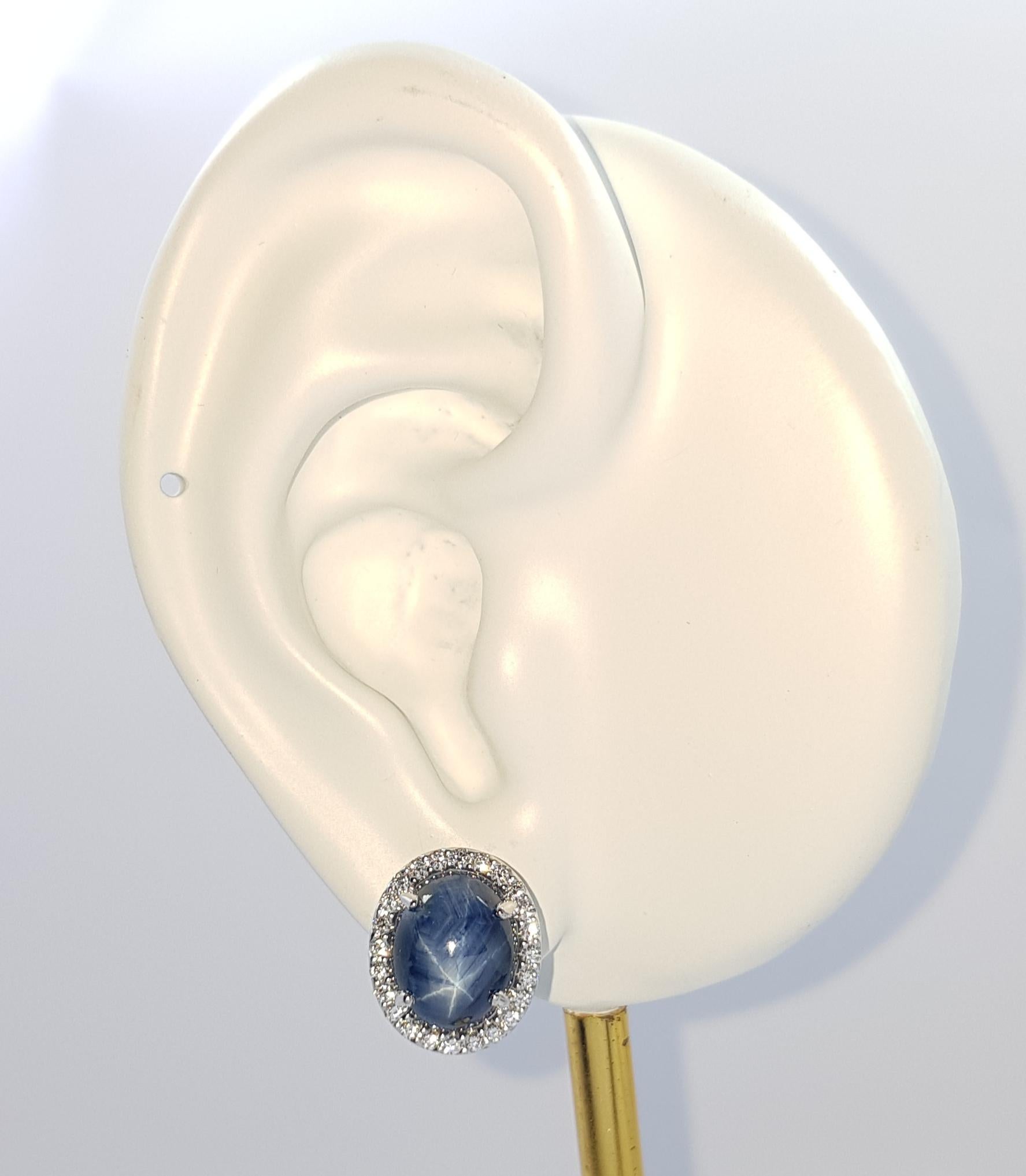 Blue Star Sapphire 9.47 carats with Diamond 0.37 carat Earrings set in 18K White Gold Settings

Width: 1.1 cm 
Length: 1.3 cm
Total Weight: 6.94 grams

