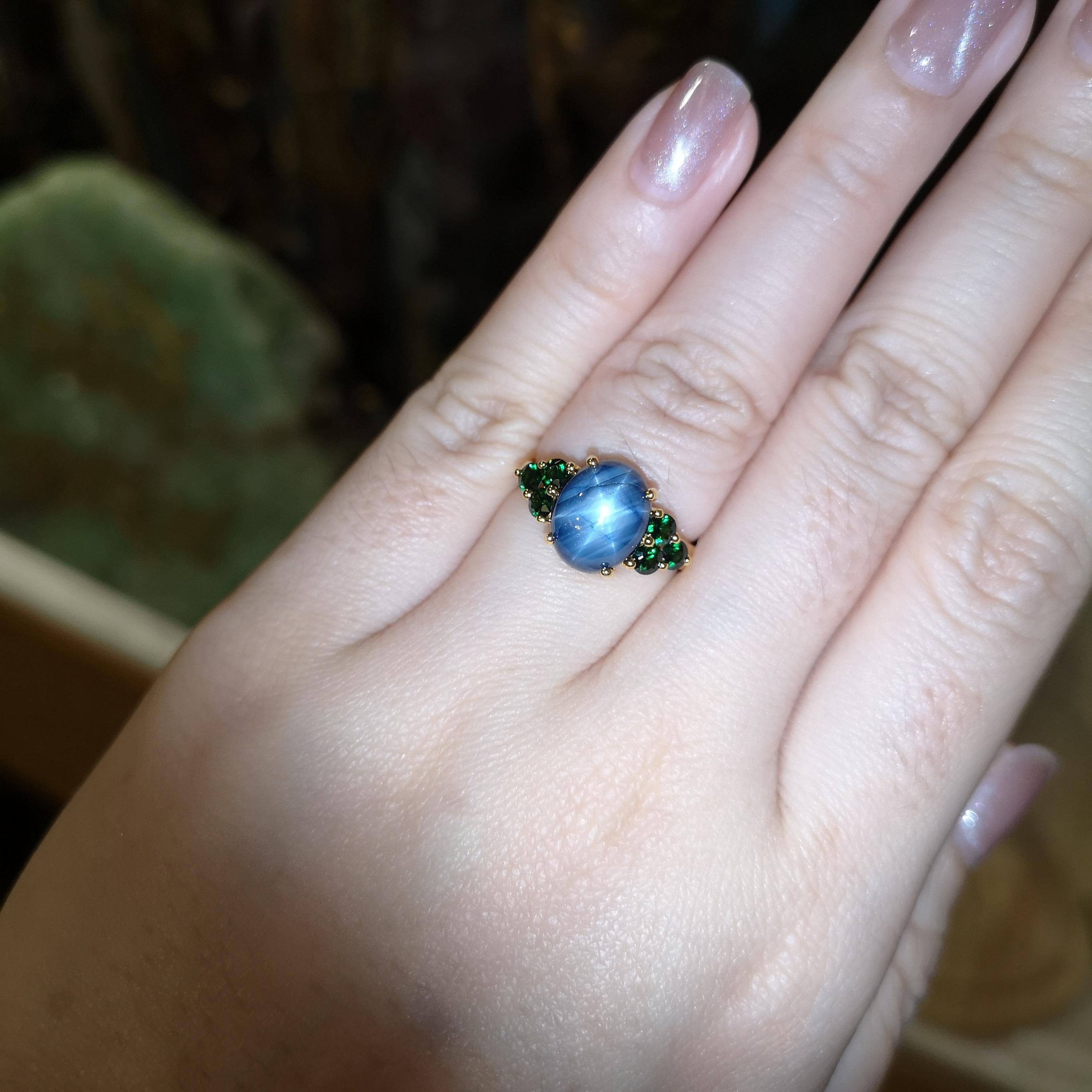 Blue Star Sapphire 5.68 carats with Tsavorite 0.67 carat Ring set in 18K Gold Settings

Width:  1.8 cm 
Length: 1.0 cm
Ring Size: 54
Total Weight: 4.65 grams

